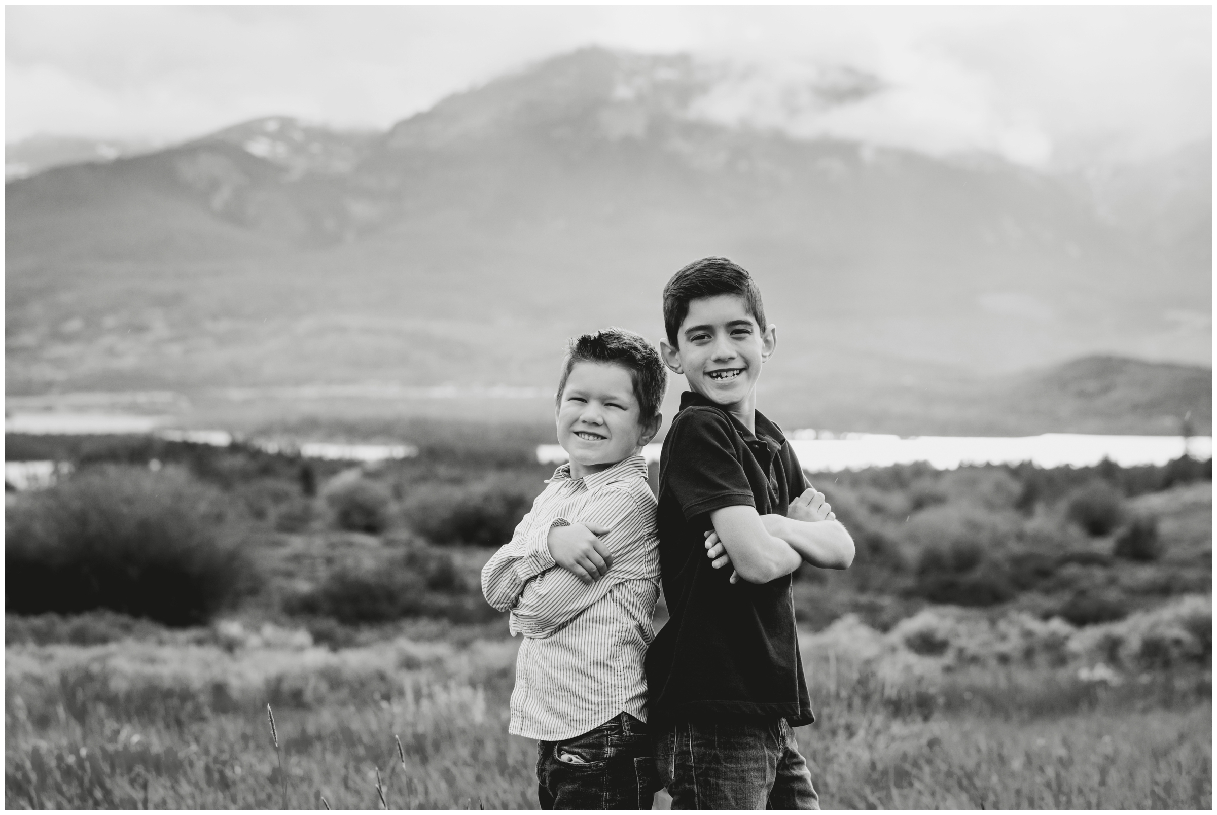 brothers posing back to back at Windy Point Campground during Breckenridge Colorado family photos 