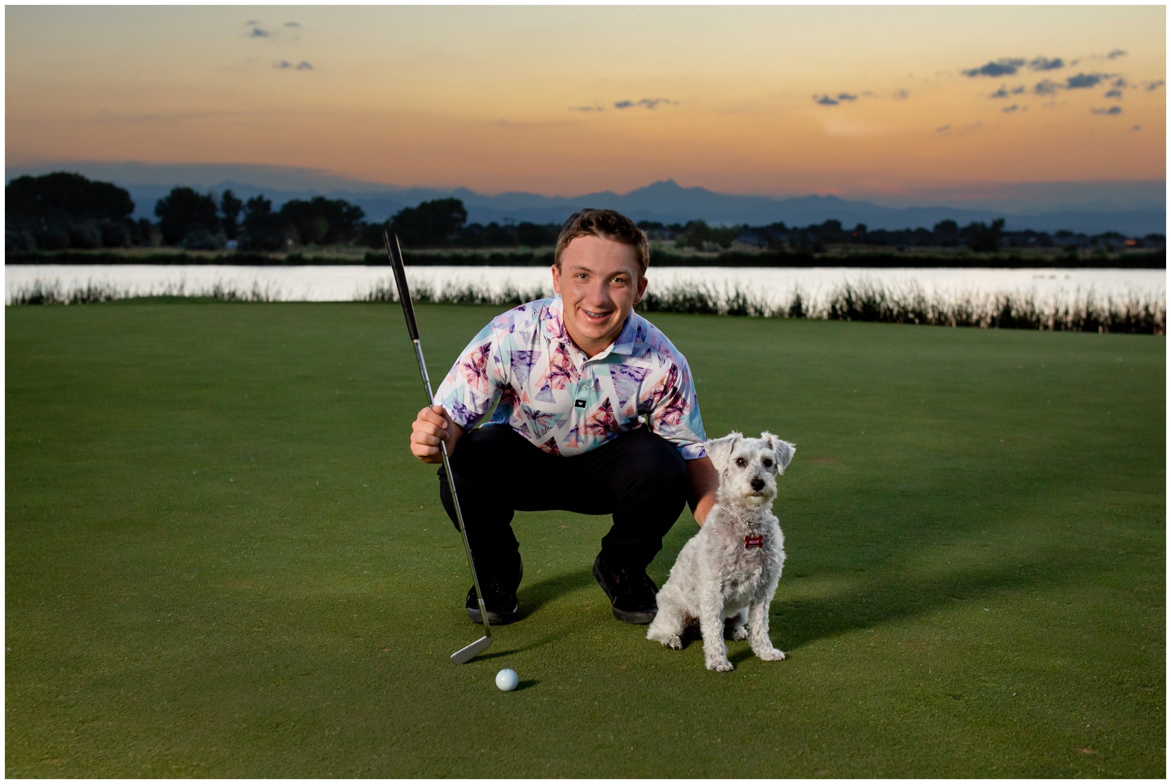 teen guy and his dog posing for senior portraits on a golf course in Colorado 