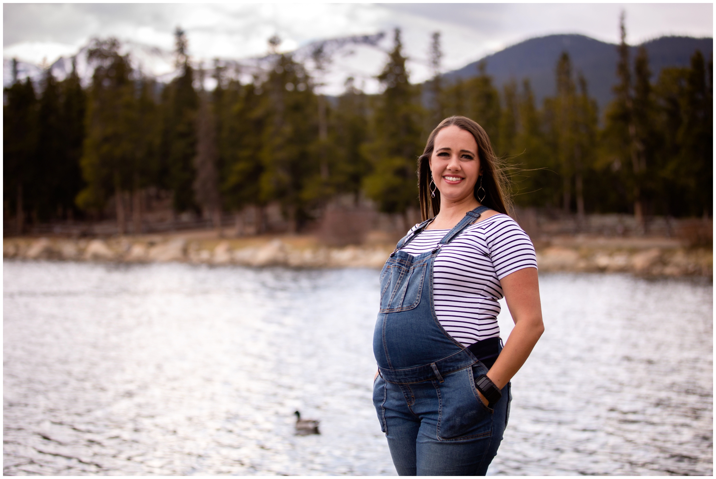 Woman in overalls during Maternity photo shoot in the Colorado mountains 