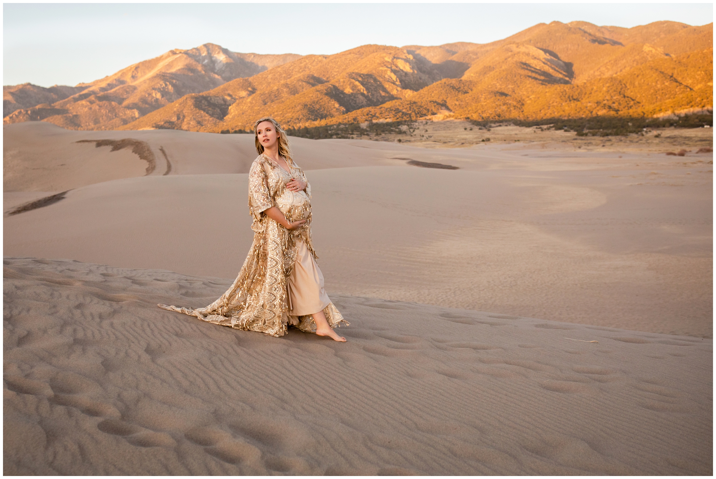 woman in boho gown walking in the sand during unique maternity portraits at the Great Sand Dunes National Park 
