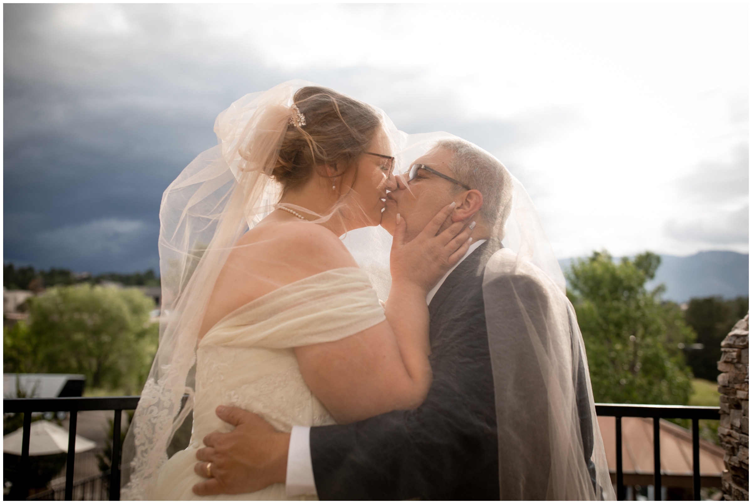 couple kissing under long veil during Colorado Springs summer wedding photos 