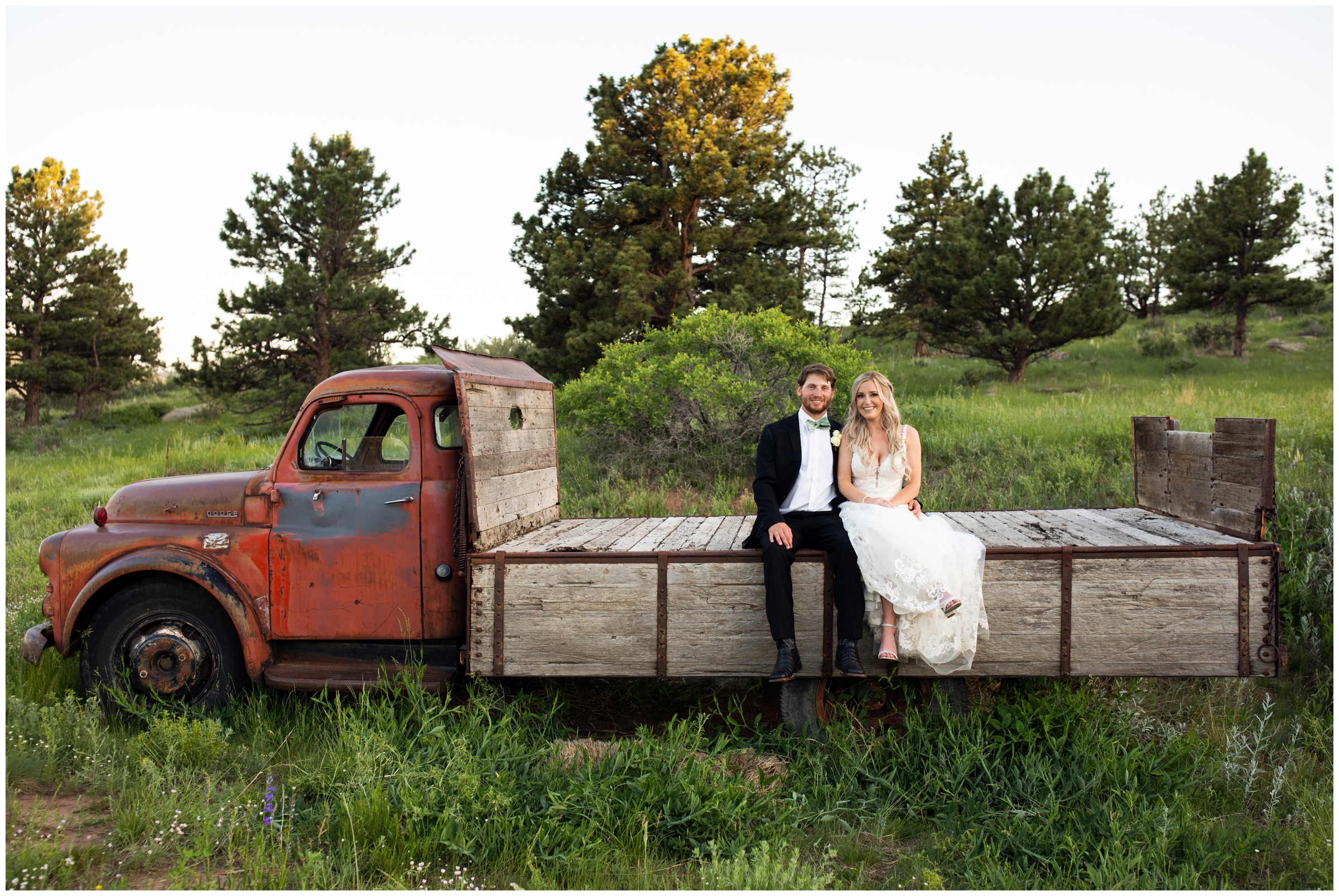 couple posing on old truck during Lionscrest Manor summer wedding photos by Lyons Colorado photographer Plum Pretty Photography