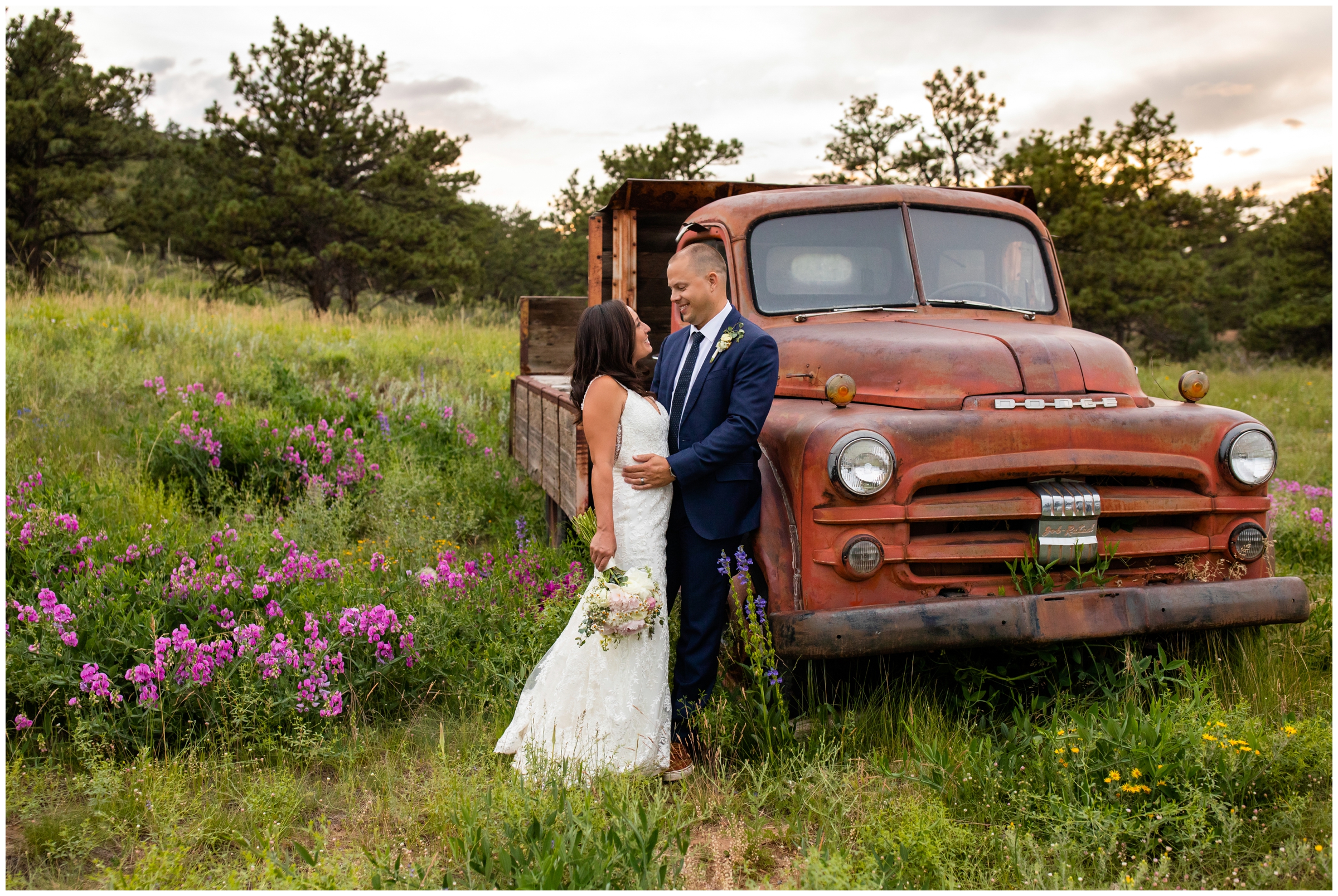 Bride and groom leaning against old vintage truck during Lionscrest manor Colorado mountain wedding pictures 