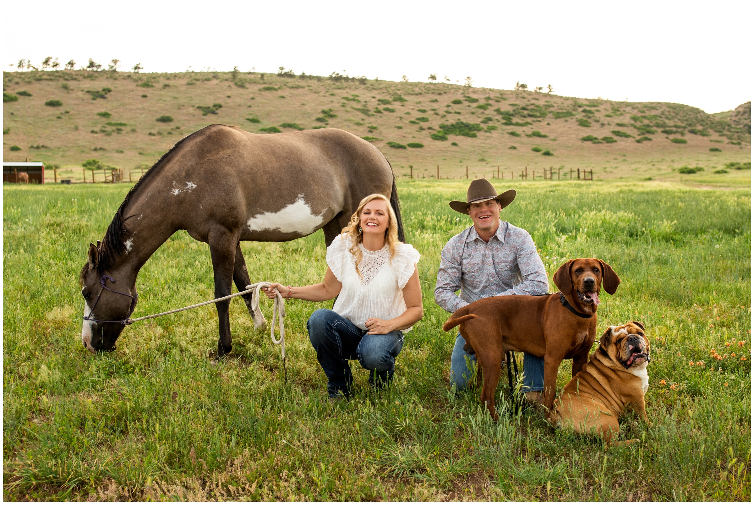 couple posing with their dogs and horses during rustic Colorado engagement portraits