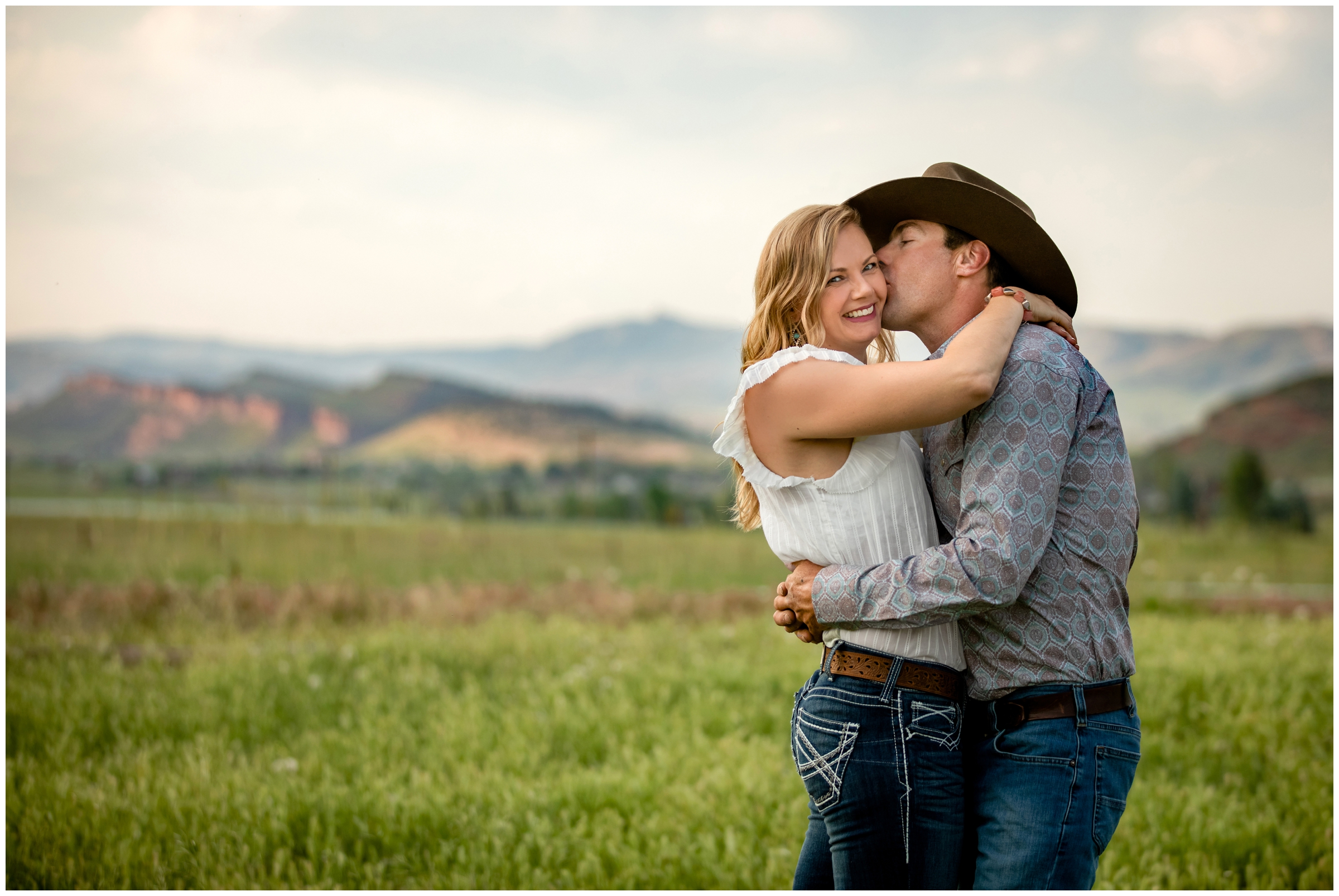 cowboy and cowgirl couple posing for rustic engagement portraits in the Colorado foothills mountains 