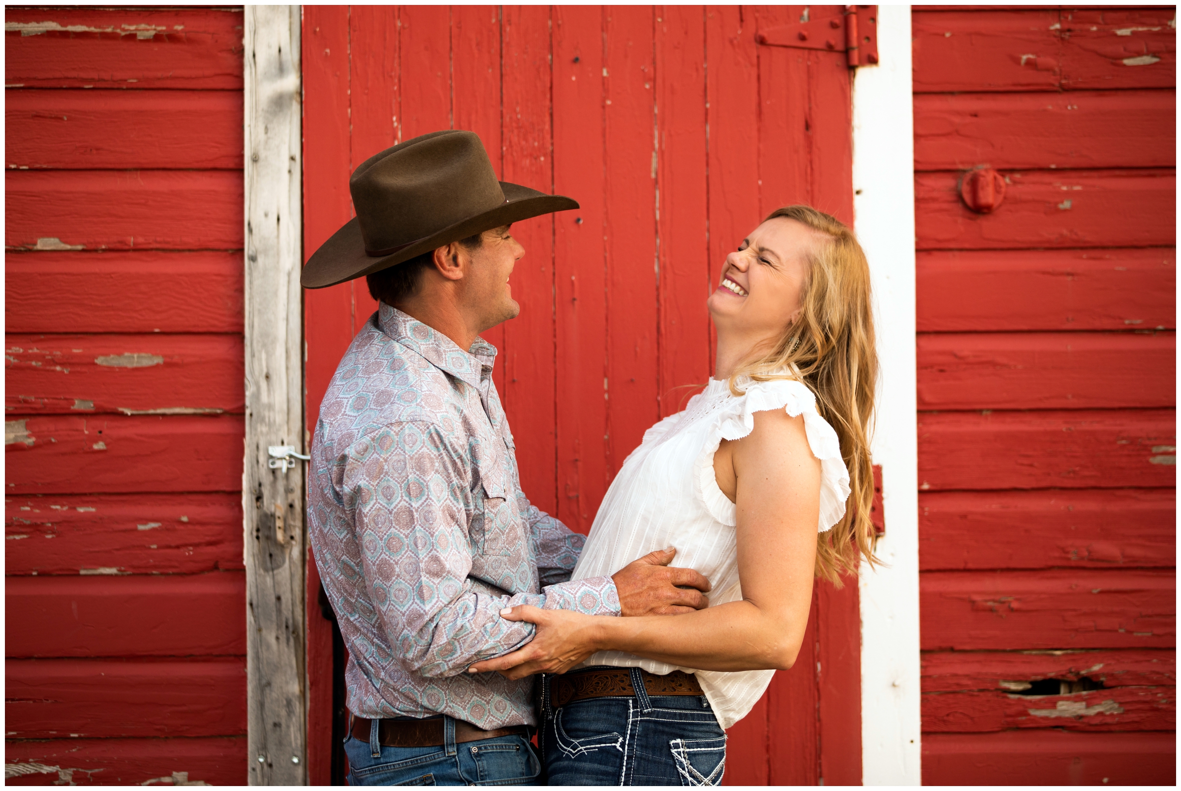 Loveland engagement pictures in front of a rustic red barn 