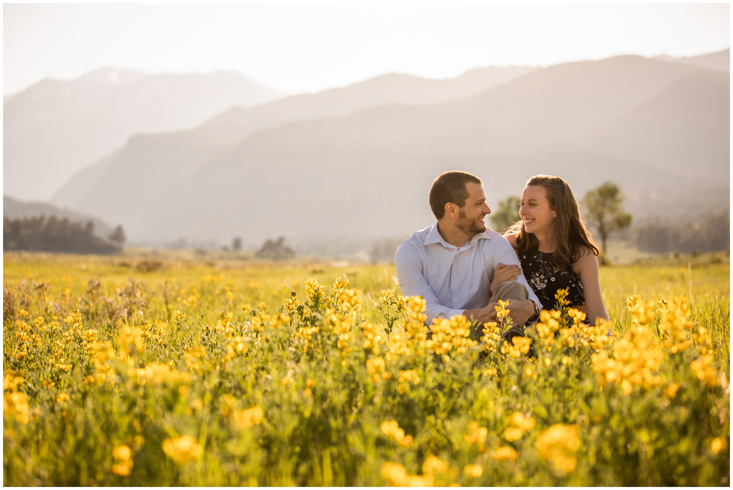 couple posing in wildflower field during RMNP Estes Park engagement photography session