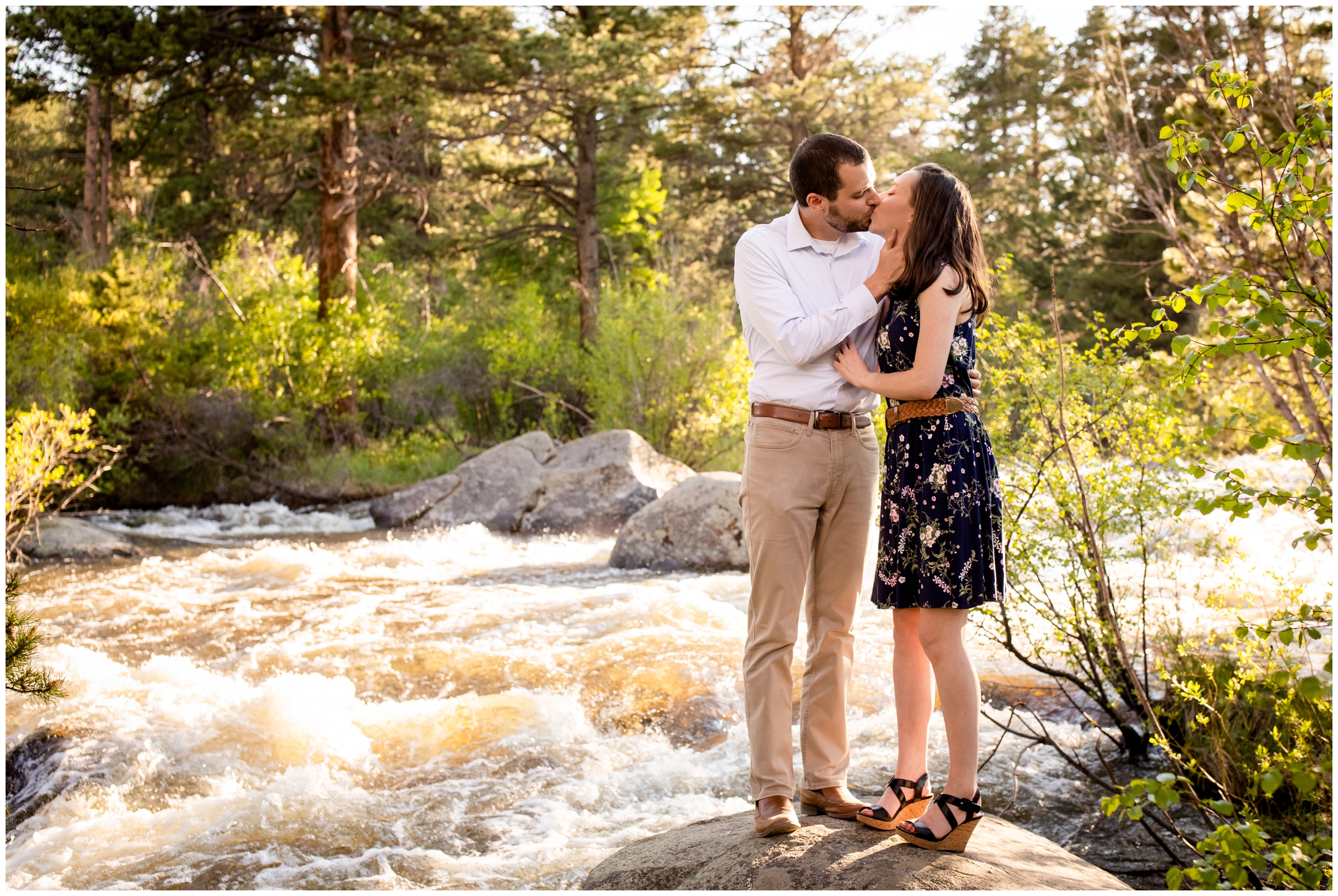 couple kissing next to a river during couples portraits in the Colorado mountains 