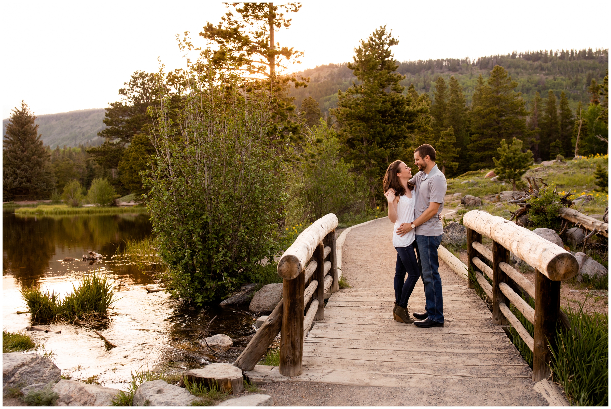 couple posing on bridge during RMNP engagement pictures at Sprague Lake 
