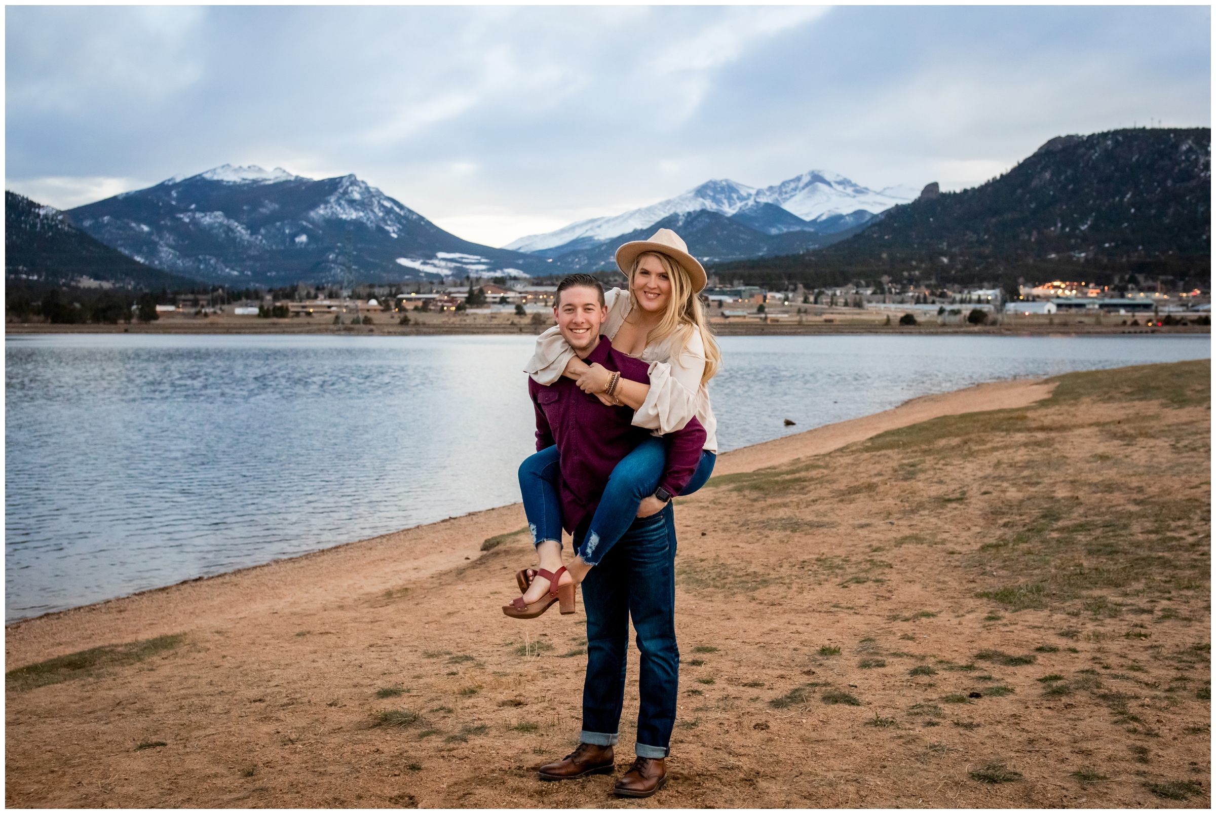 guy giving his fiancé a piggy back ride during Estes Park Colorado engagement photos 