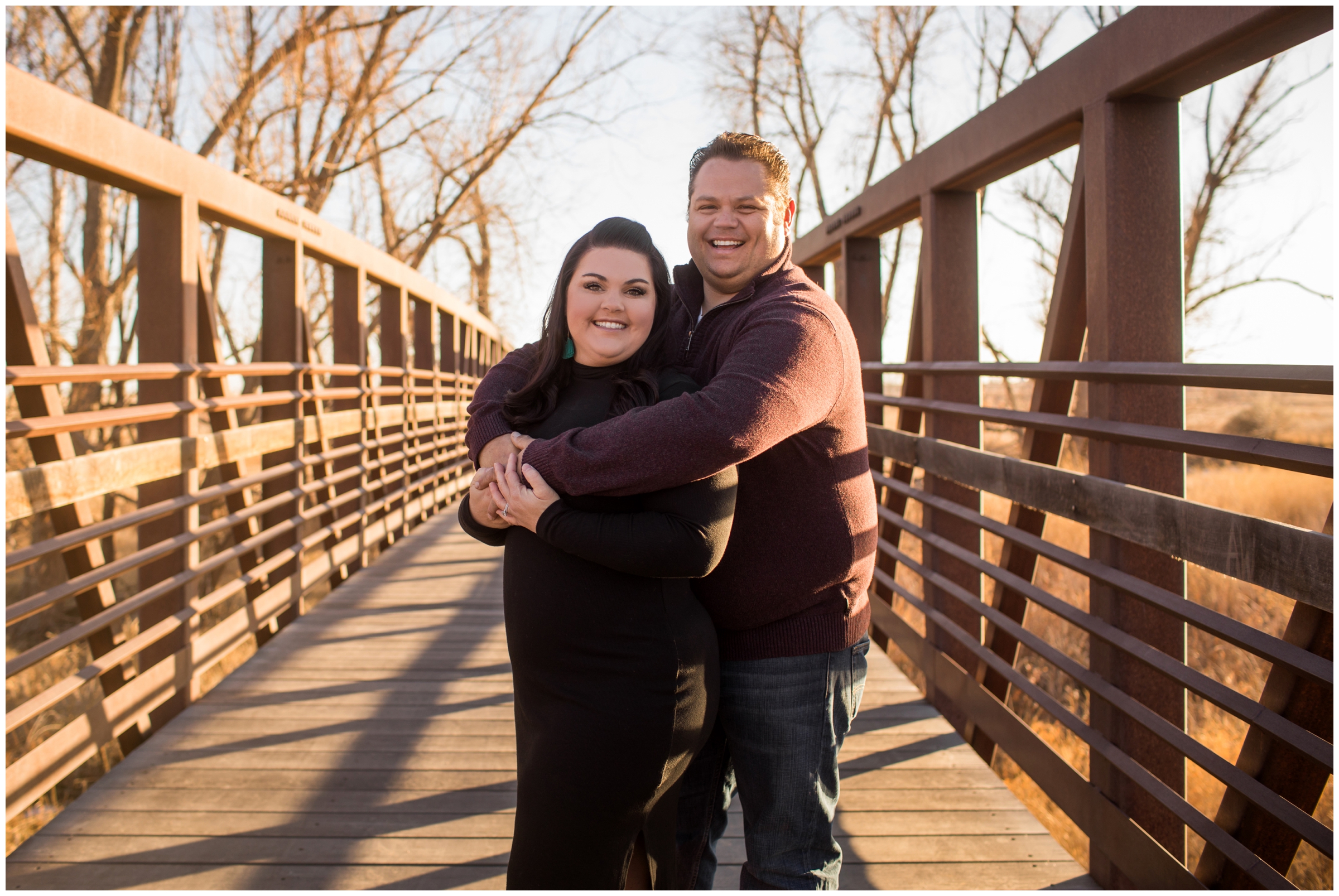 couple embracing on bridge during Colorado couple's portraits at Sandstone Ranch in Longmont 