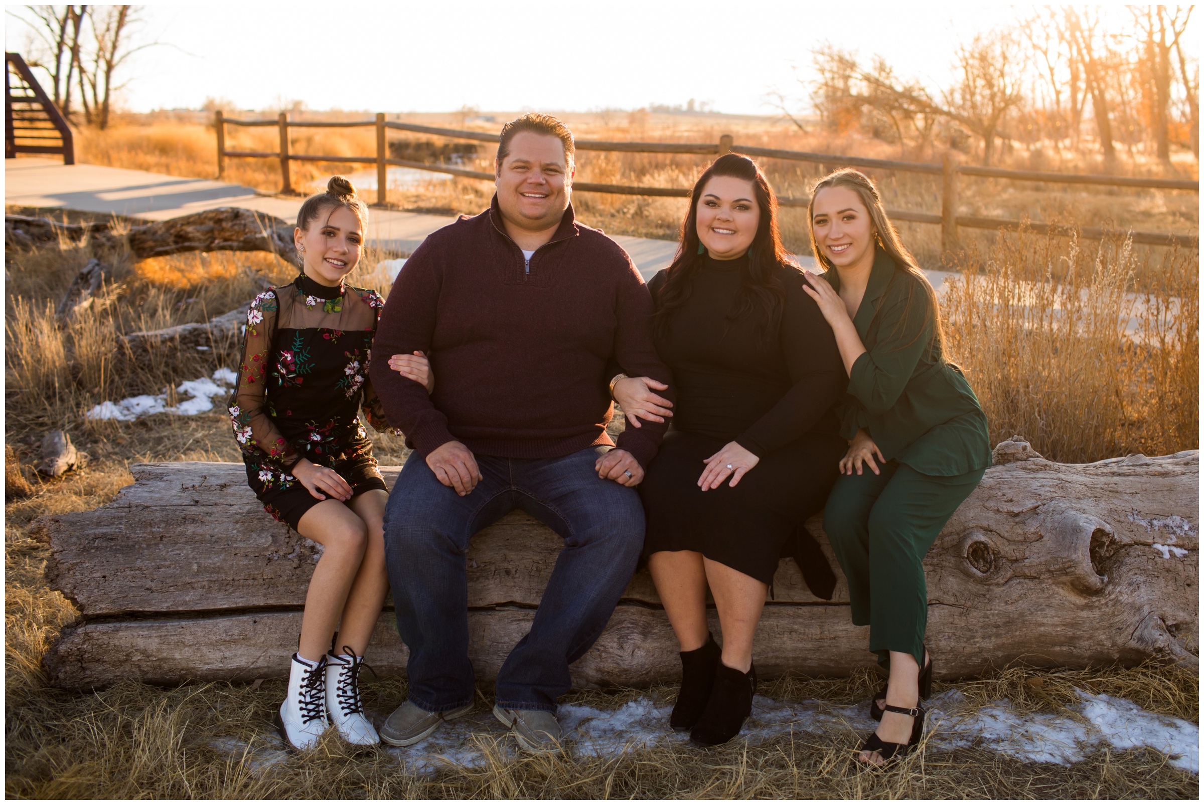 family sitting on tree log during Sandstone Ranch Longmont family portrait session 