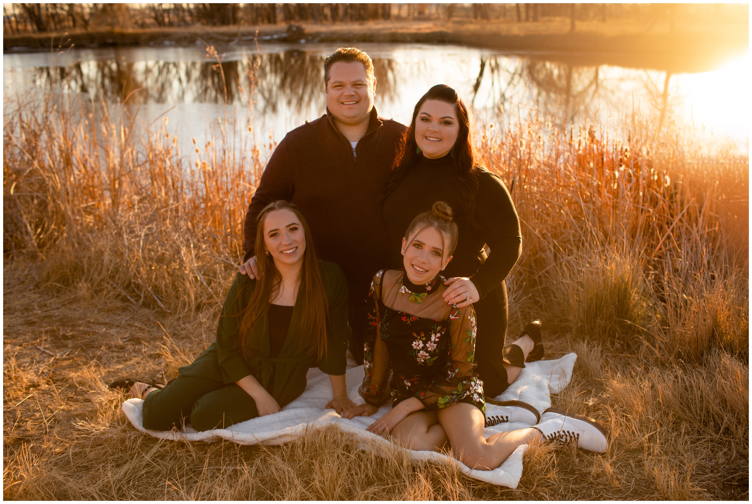 family posing on blanket during sunny fall family pictures in Longmont 