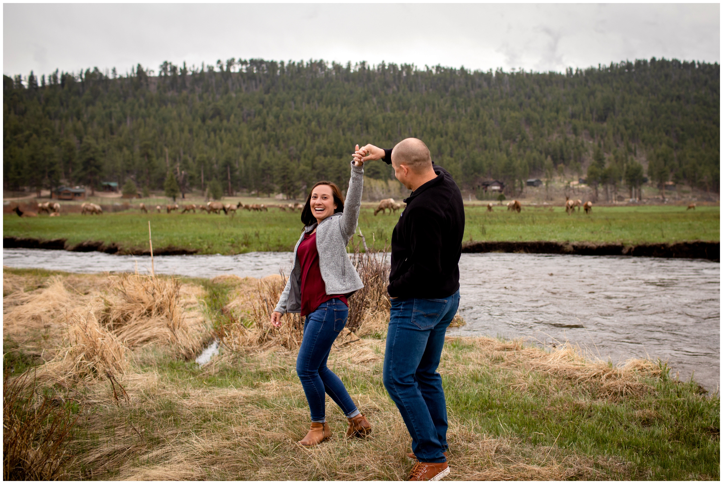 couple dancing next to a river with elk in background during Colorado mountain engagement pictures