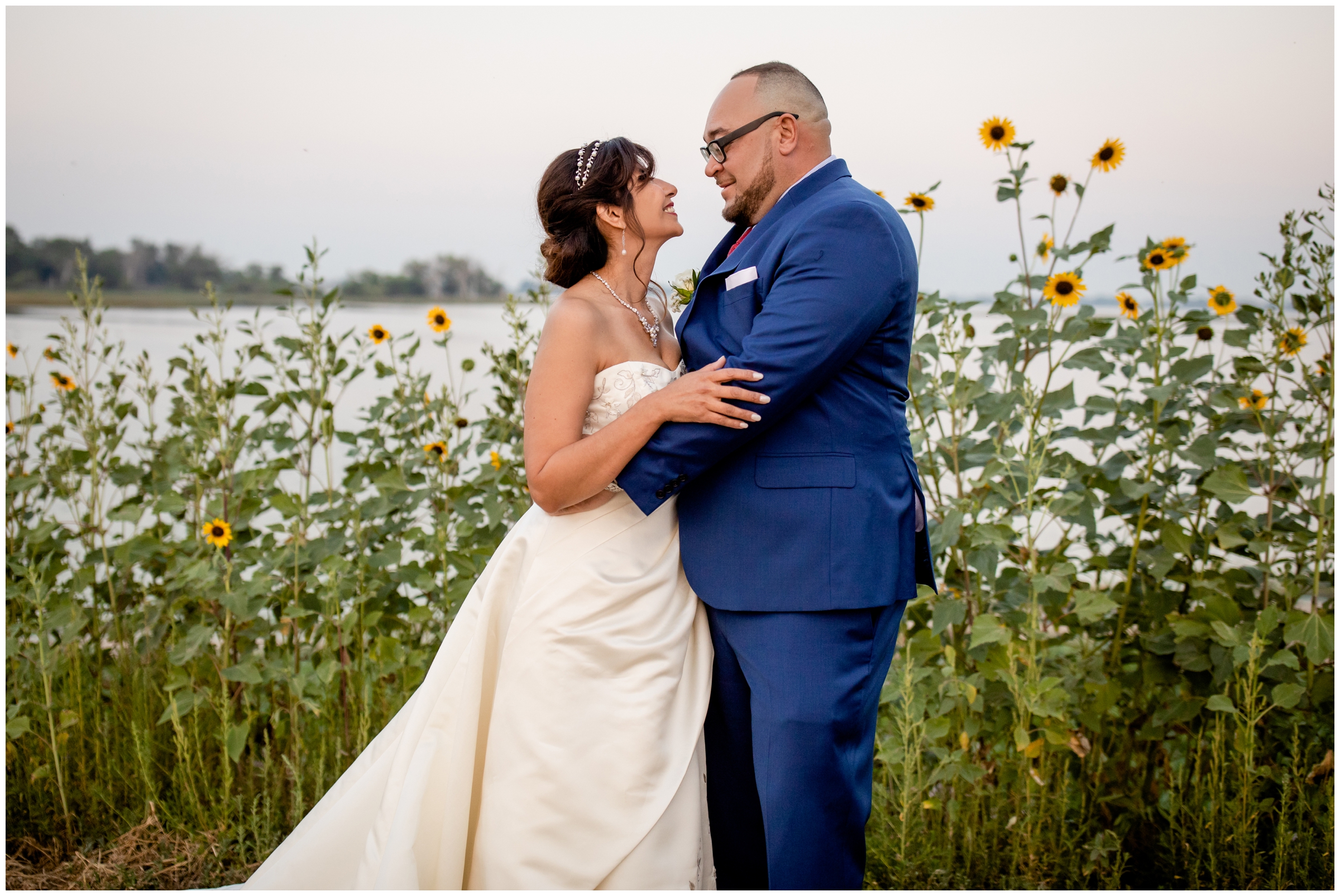 couple posing next to sunflowers during Colorado sunrise morning elopement photography session at Barr Lake State Park 
