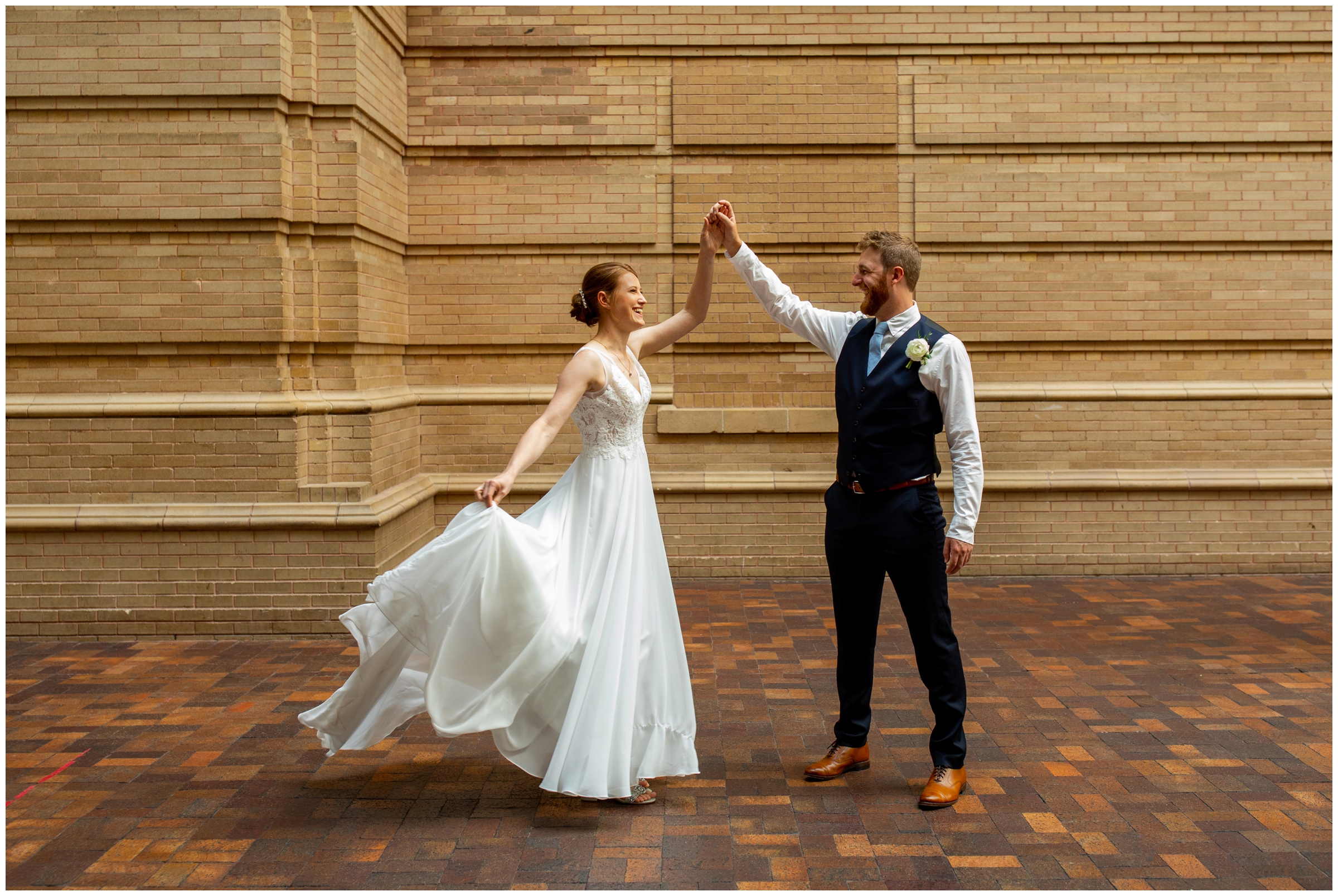 groom spinning bride during Denver Colorado museum of nature and science wedding pictures 