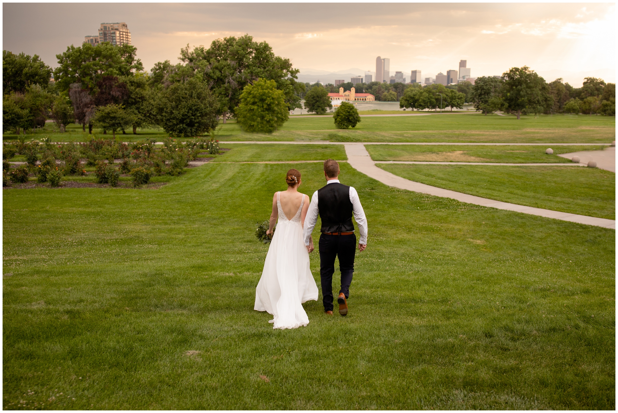 bride and groom walking through city park during Denver Colorado summer wedding 