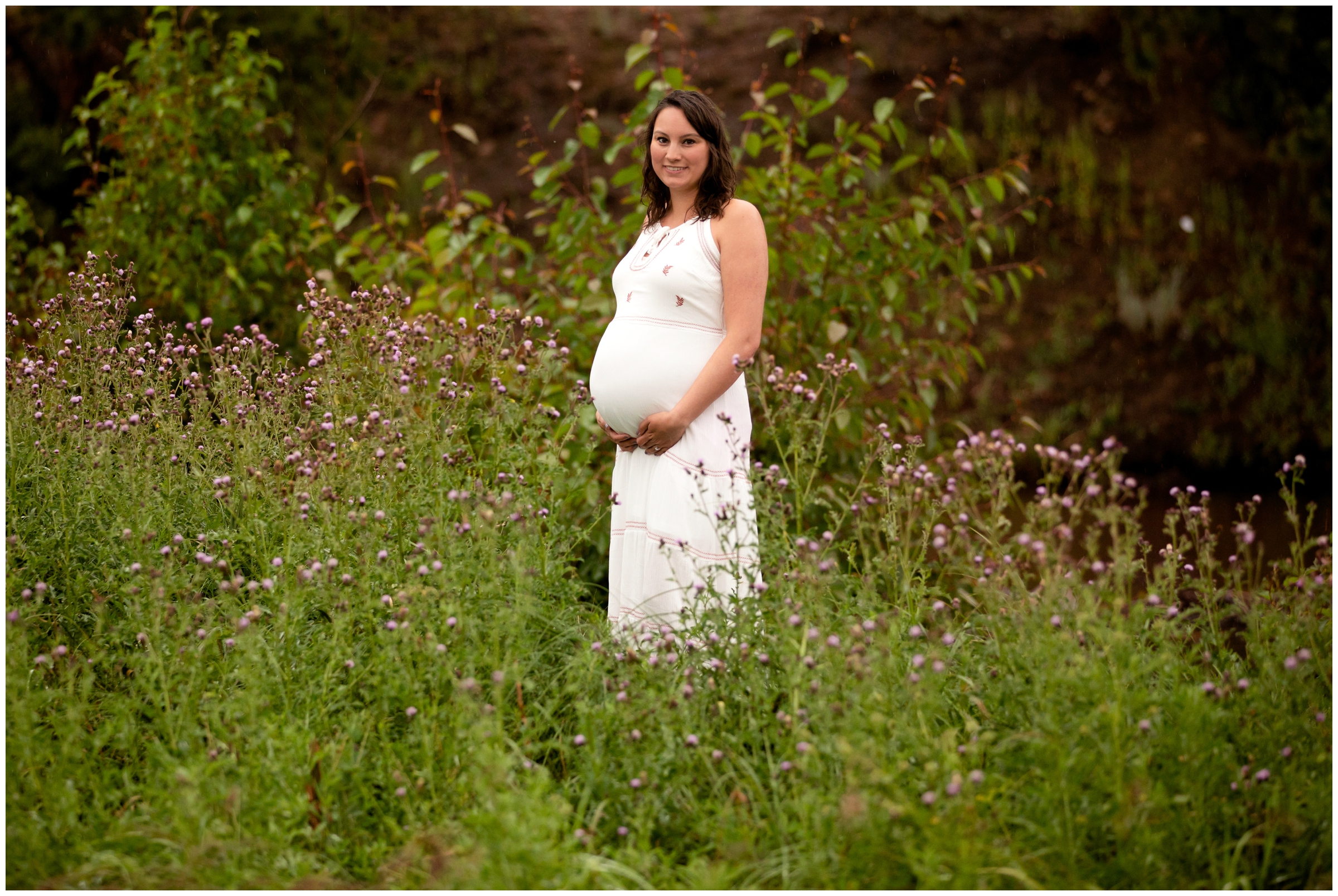 pregnant woman posing in wildflower field during Colorado maternity photography session 