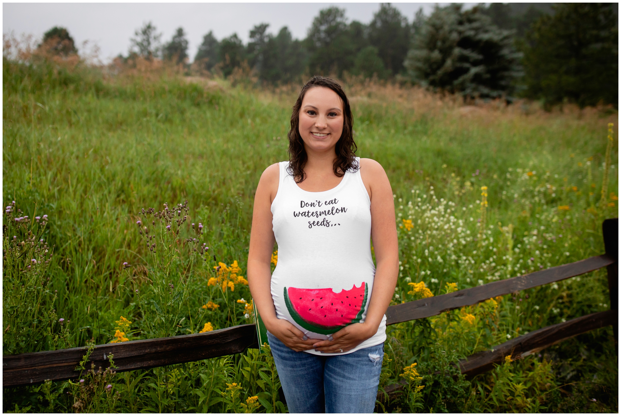woman wearing funny maternity tank top in Colorado mountains 