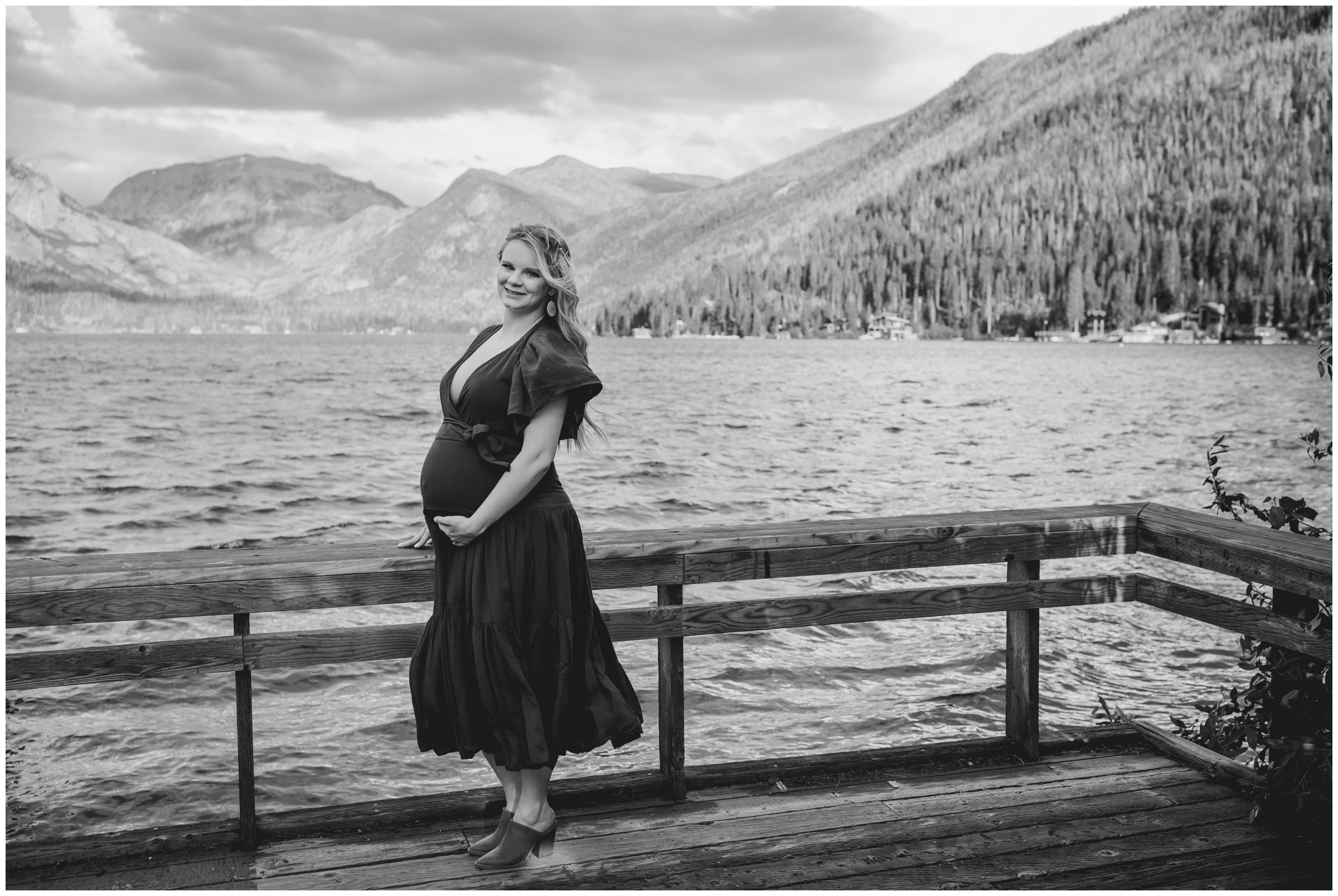 pregnant woman posing on wooden dock at Point Park during Grand Lake Colorado maternity pictures 