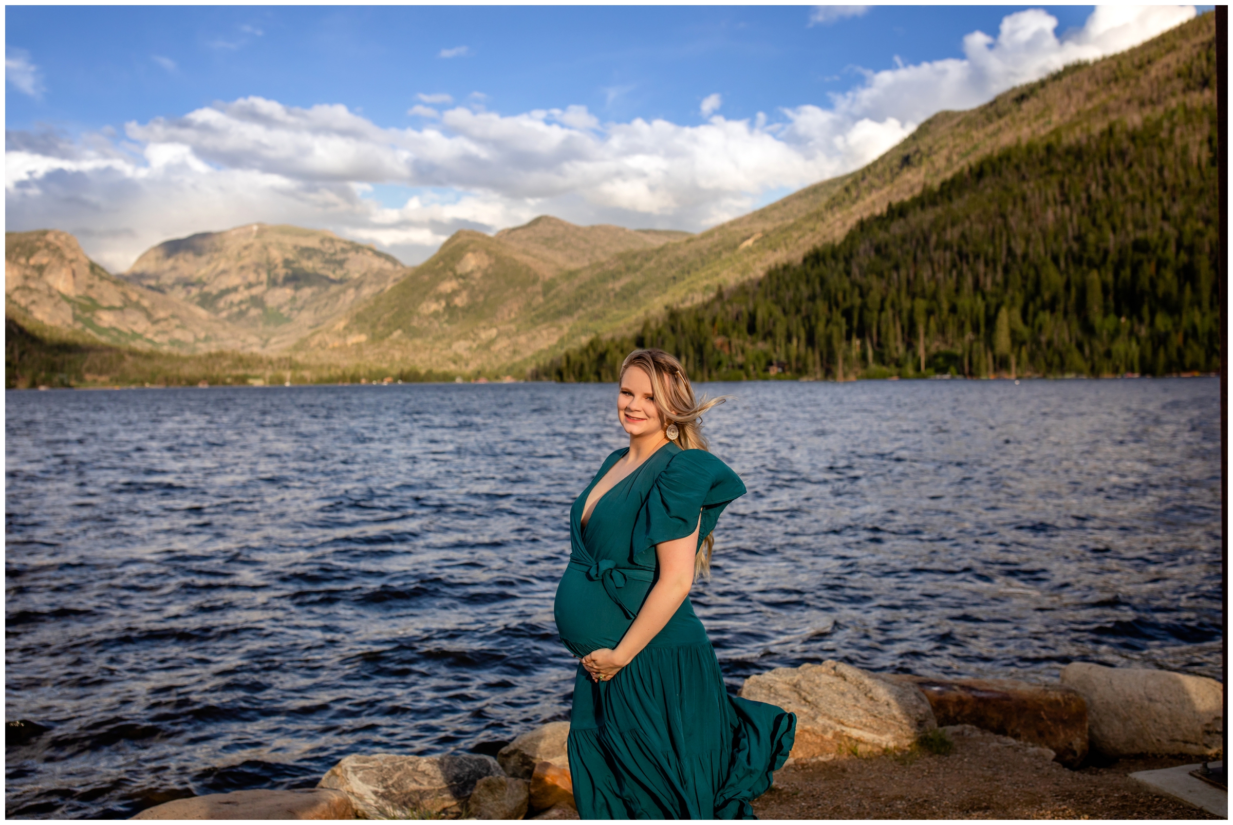 pregnant woman posing my a mountain lake in Colorado 