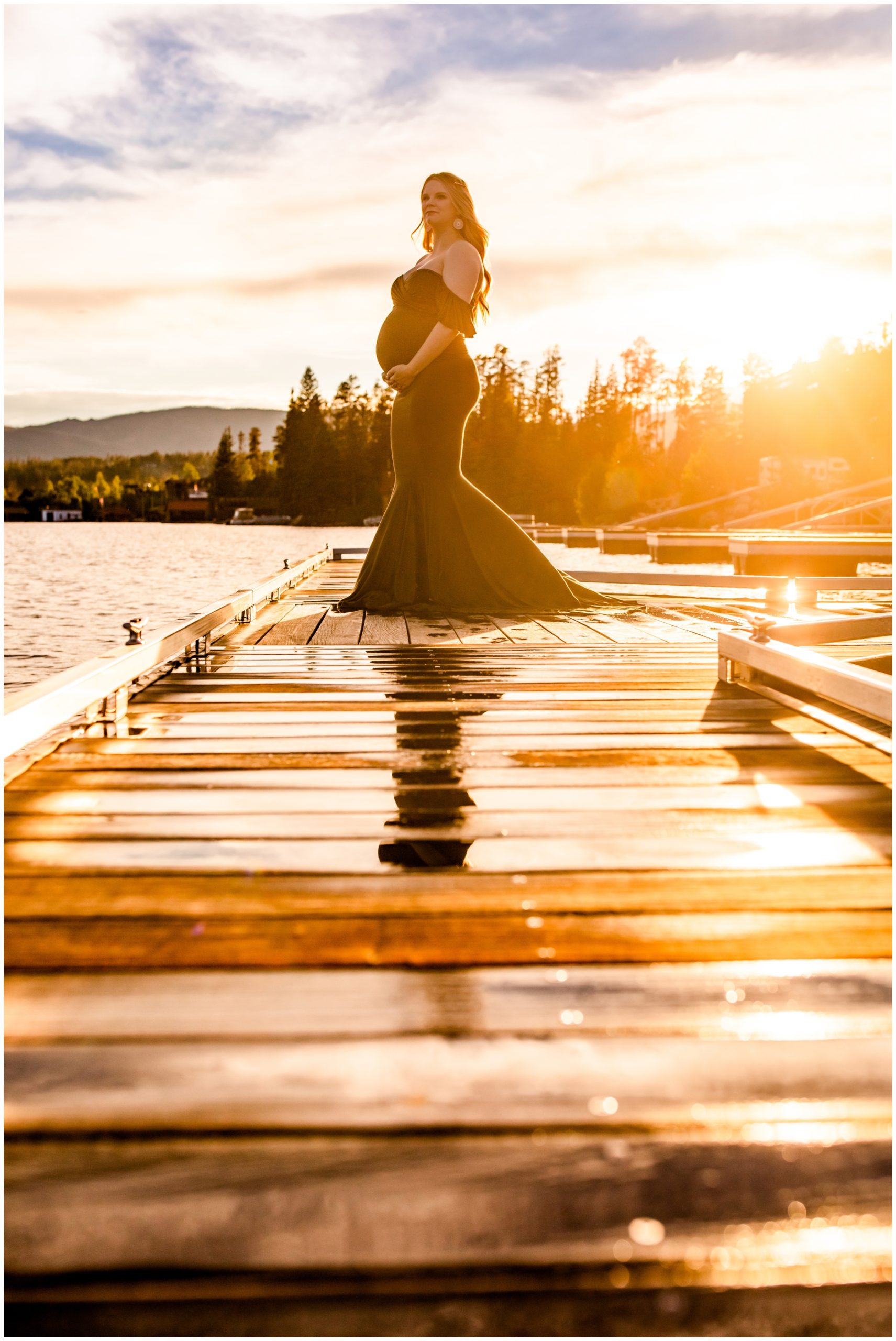 woman posing on dock during sunny Colorado mountain maternity photography session 