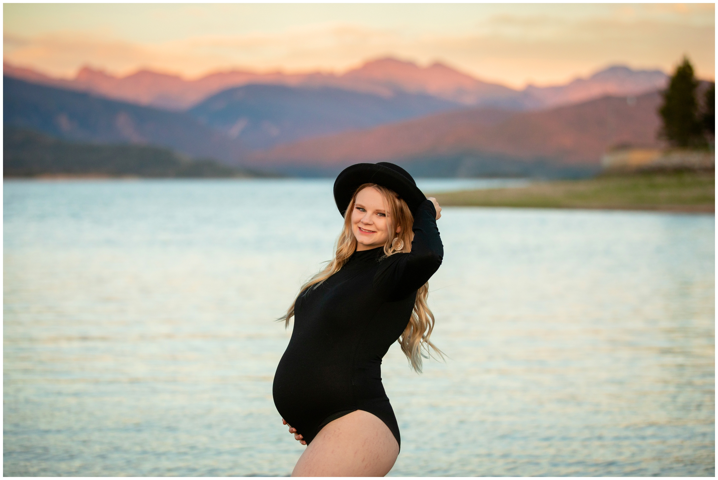 woman in black bodysuit and hat posing for Colorado mountain maternity portraits in Grand Lake Colorado 