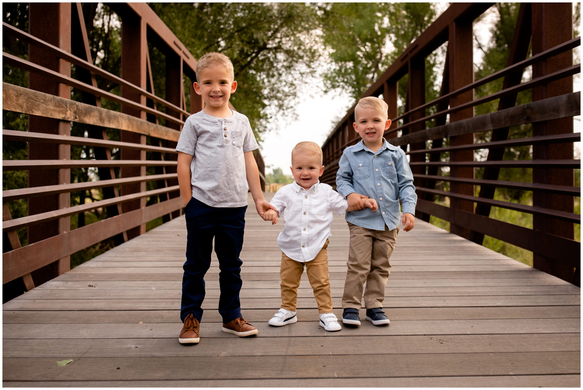 little boys on bridge during Longmont Colorado family photography session in Longmont Colorado by Plum Pretty Photos