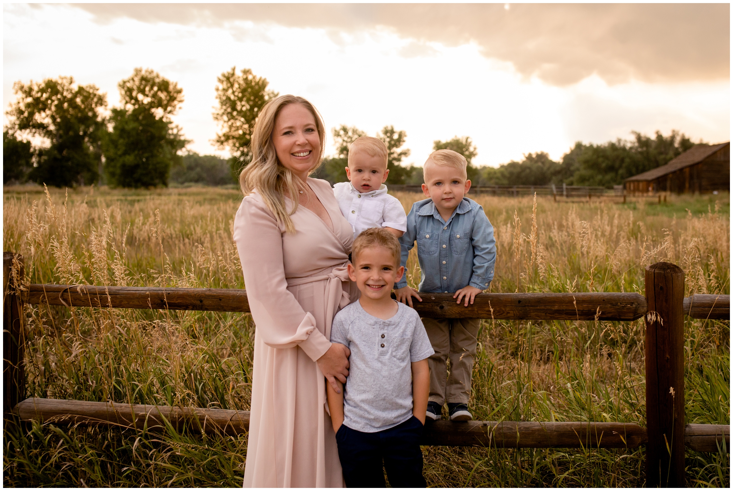 mom posing with her three sons during rustic Colorado family photos at Sandstone Ranch Longmont 
