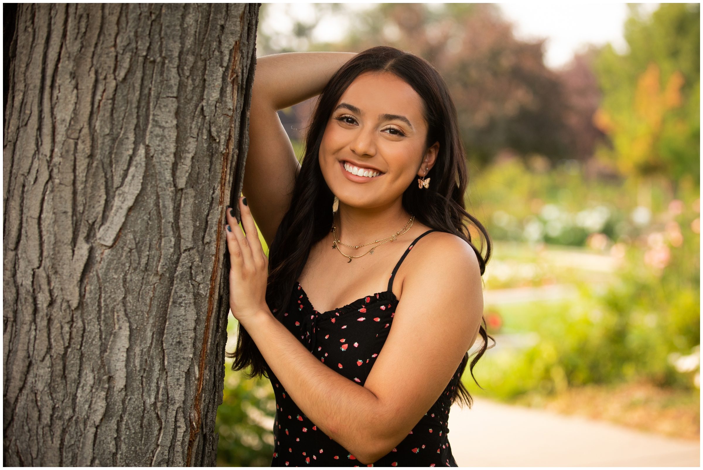 teen leaning against a tree during Longmont senior photo shoot in Colorado 