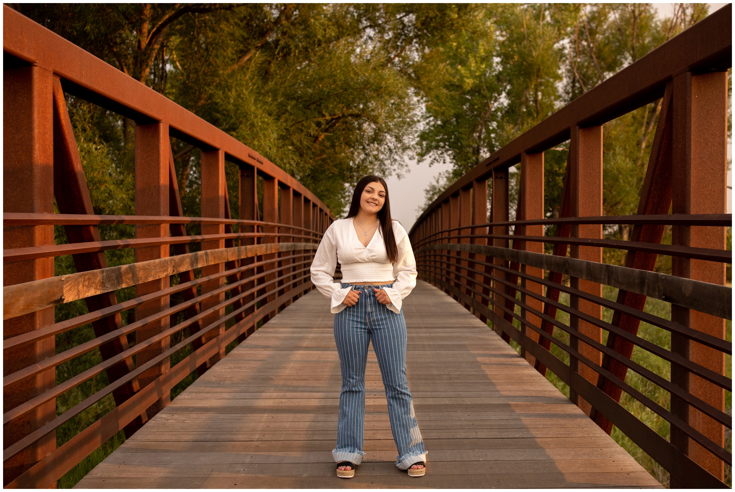 Colorado graduation portraits on a bridge in Longmont Colorado 