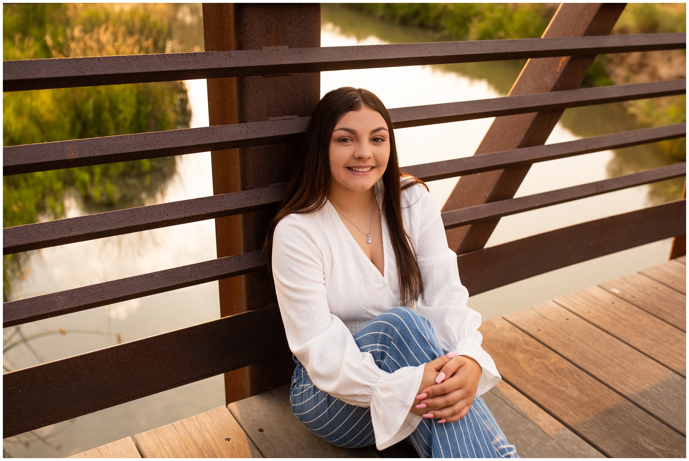 teen sitting on bridge during Longmont senior pictures 