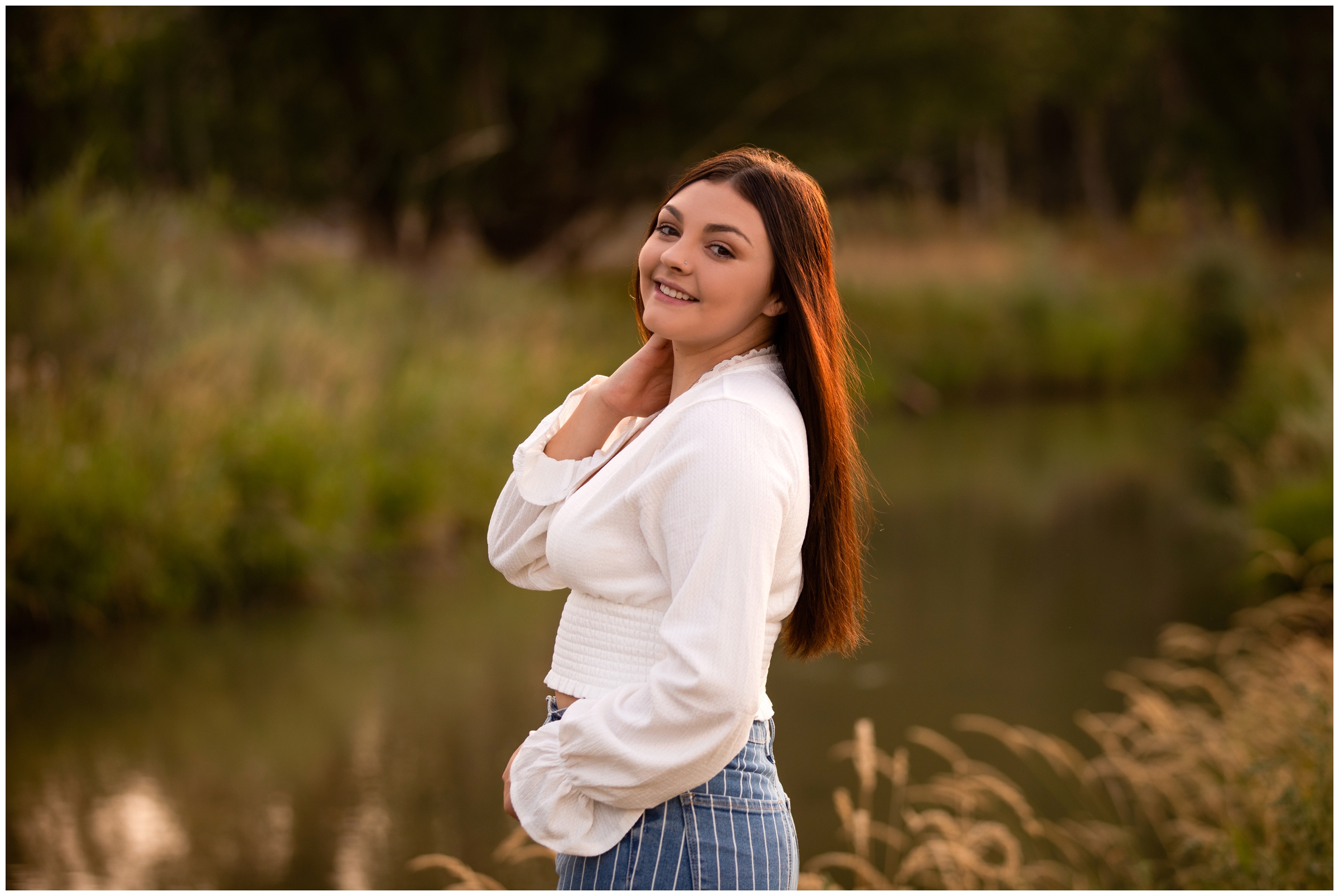 teen posing by river during Longmont Colorado senior session 
