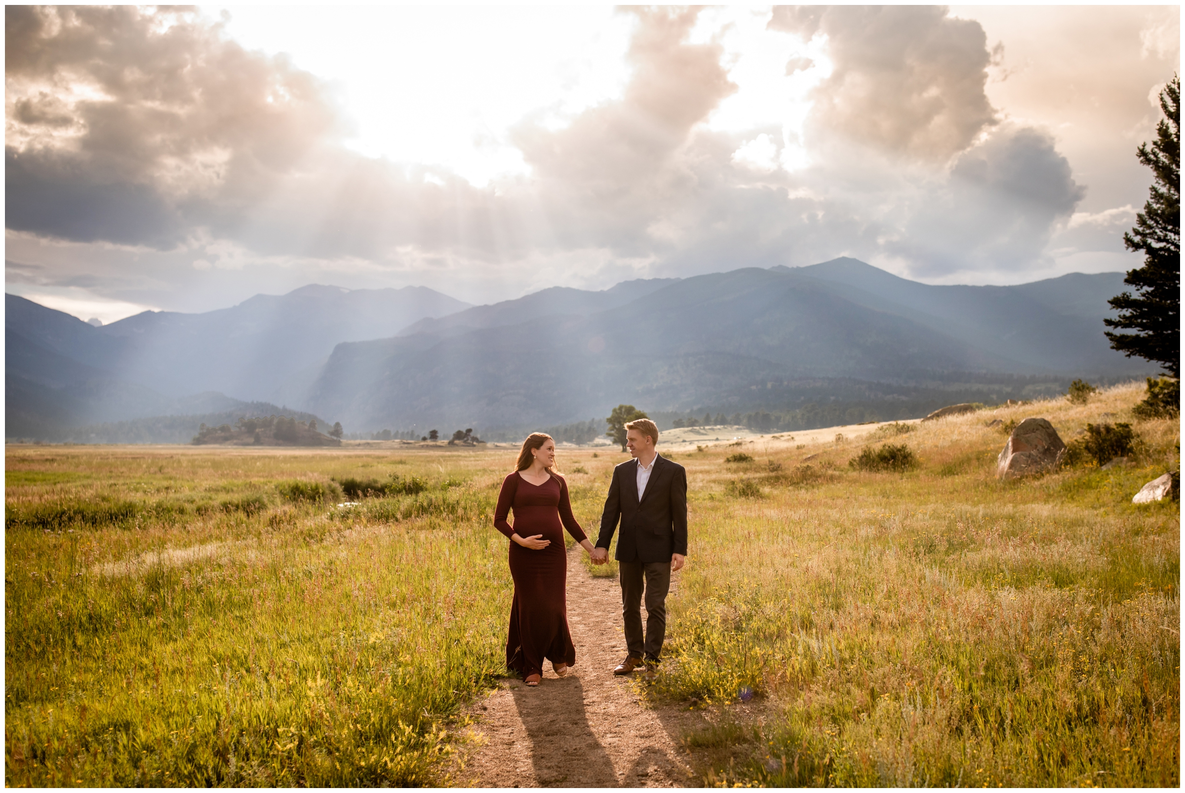 couple walking down dirt road during Estes Park maternity photo shoot in RMNP 