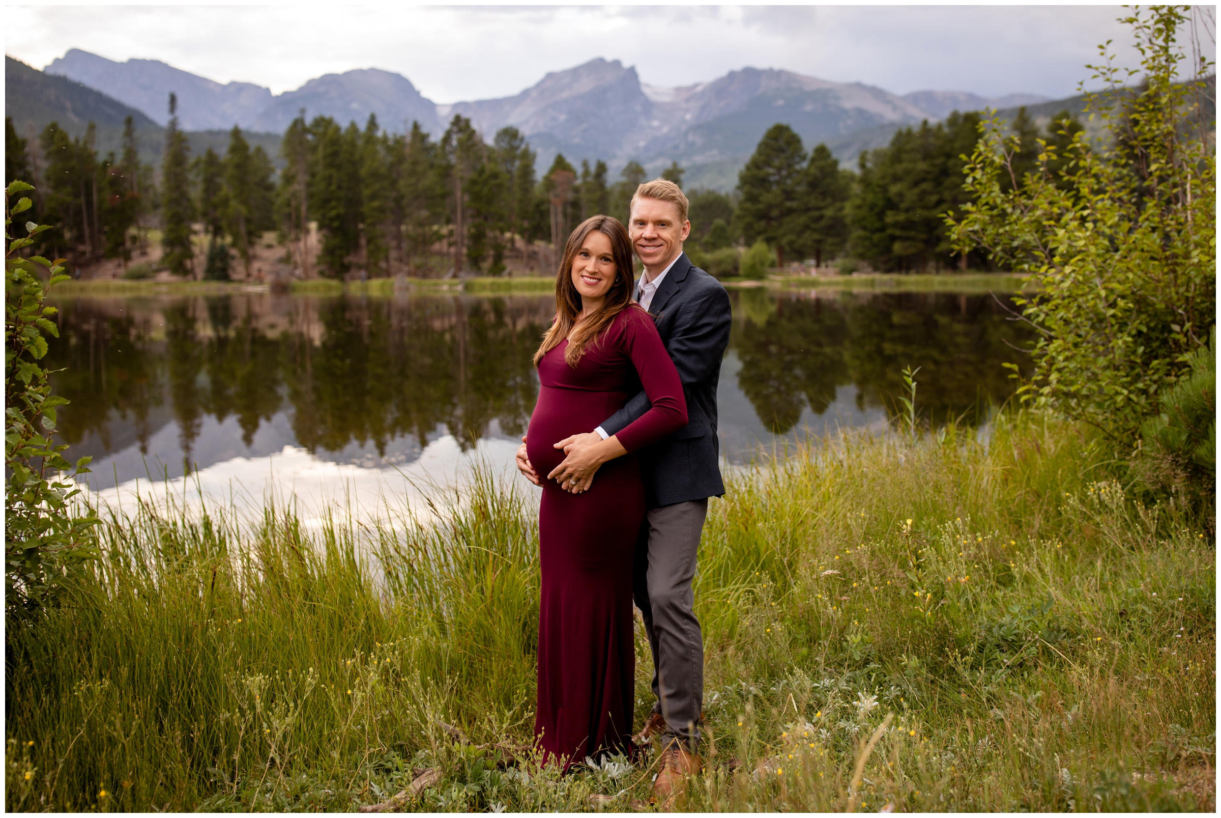 couple posing next to sprague Lake during Colorado mountain maternity pictures in RMNP