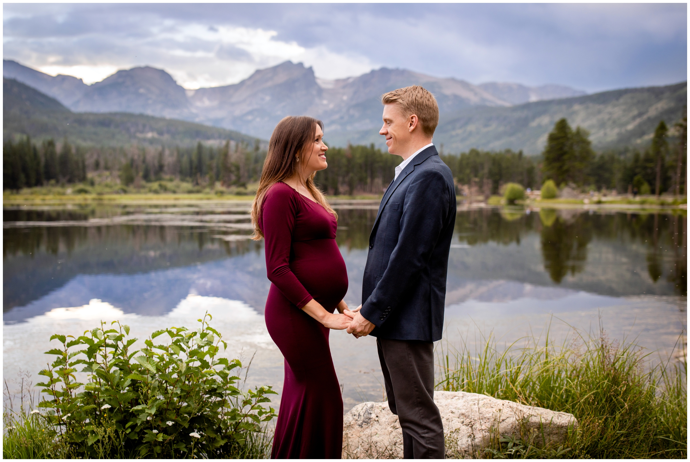 couple posing in front of mountain lake during RMNP maternity portraits at Sprague Lake