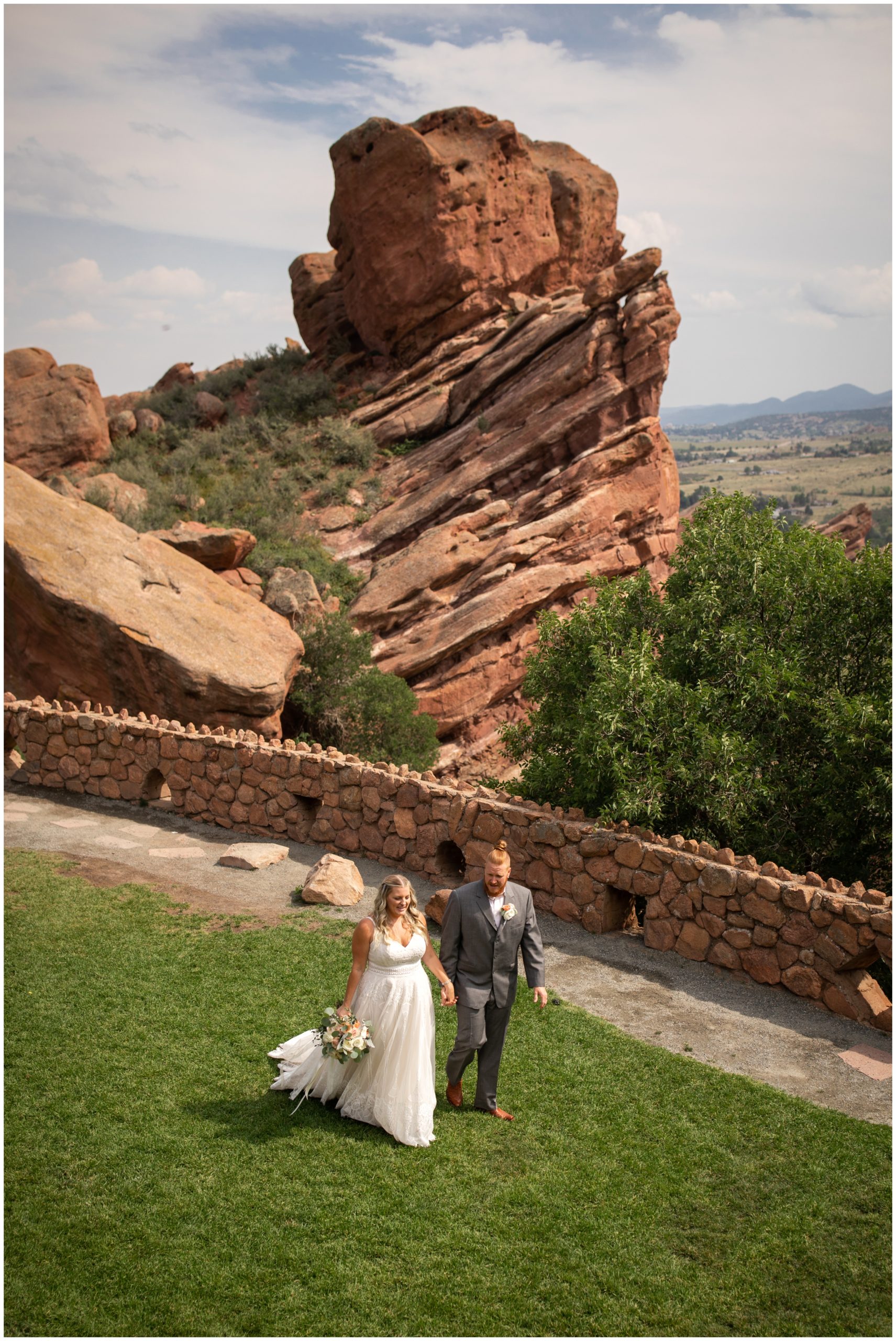 couple walking at trading post during red rocks wedding pictures by Plum Pretty Photo 