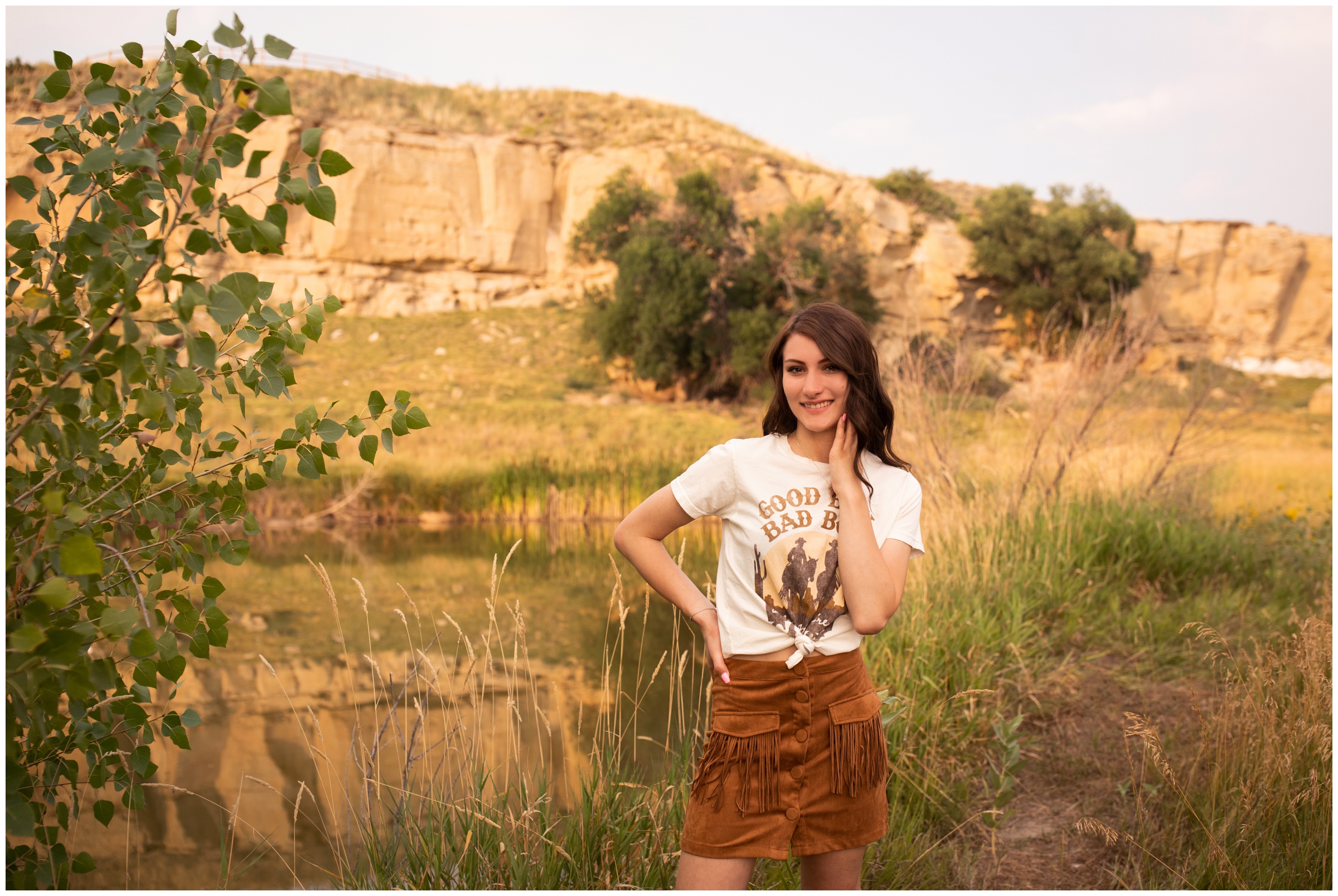 Teen posing with rock cliffs in background at sandstone ranch Colorado 