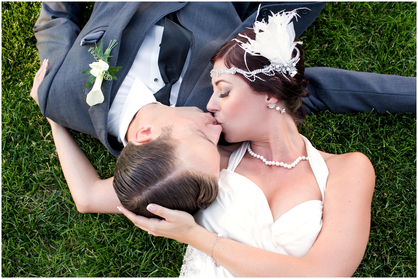 picture of bride & groom laying in the grass
