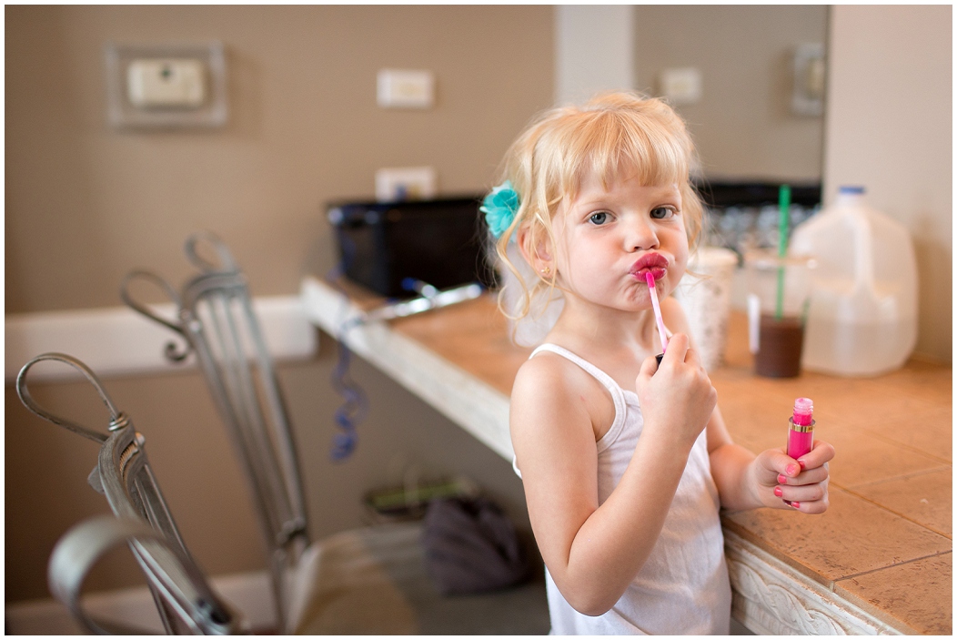 picture of flower girl putting on lipstick