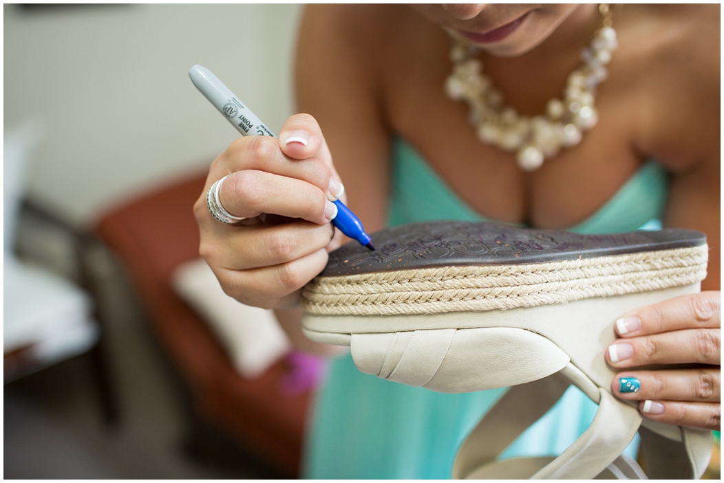 picture of bridesmaid signing bride's shoe
