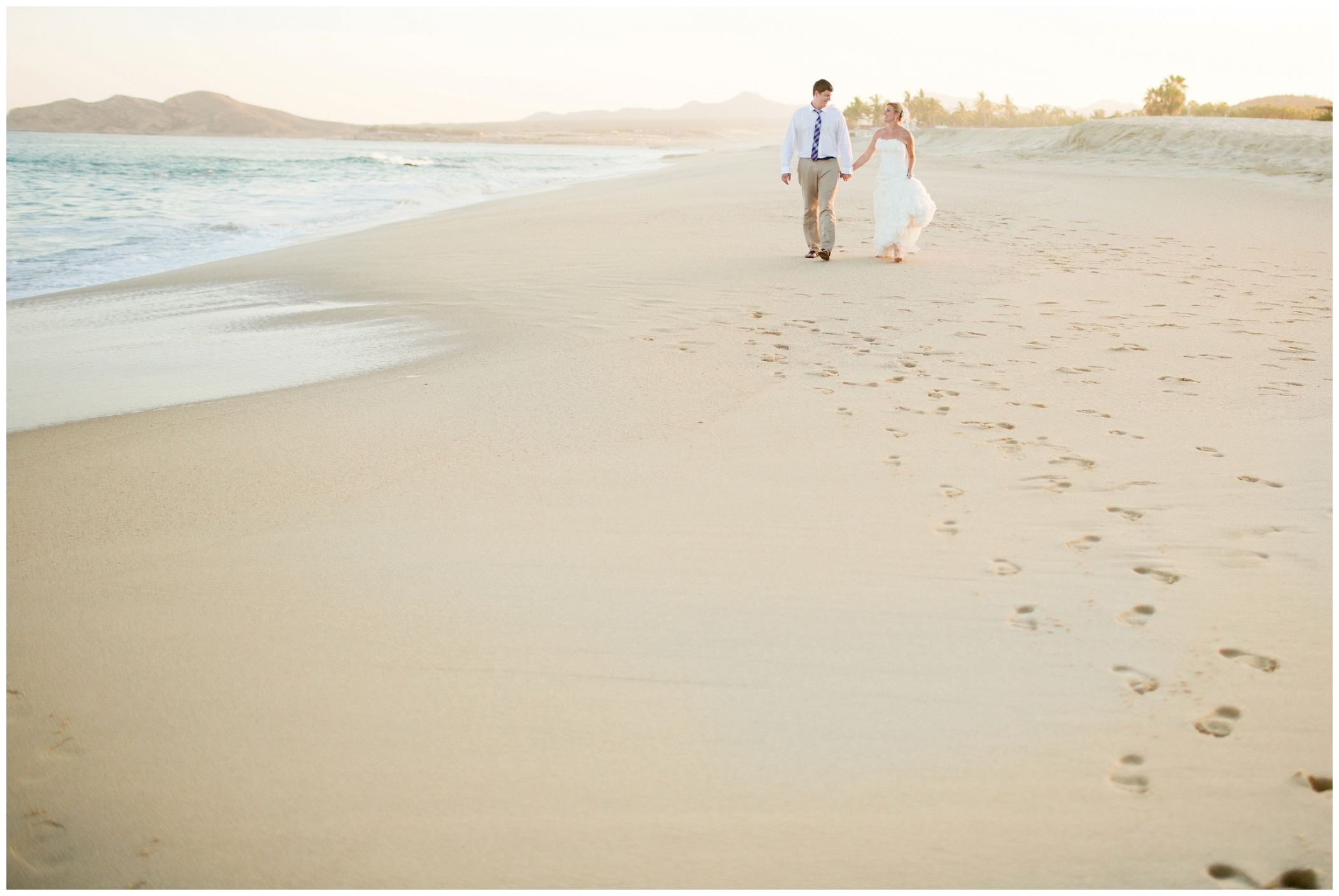 picture of bride and groom walking on the beach 
