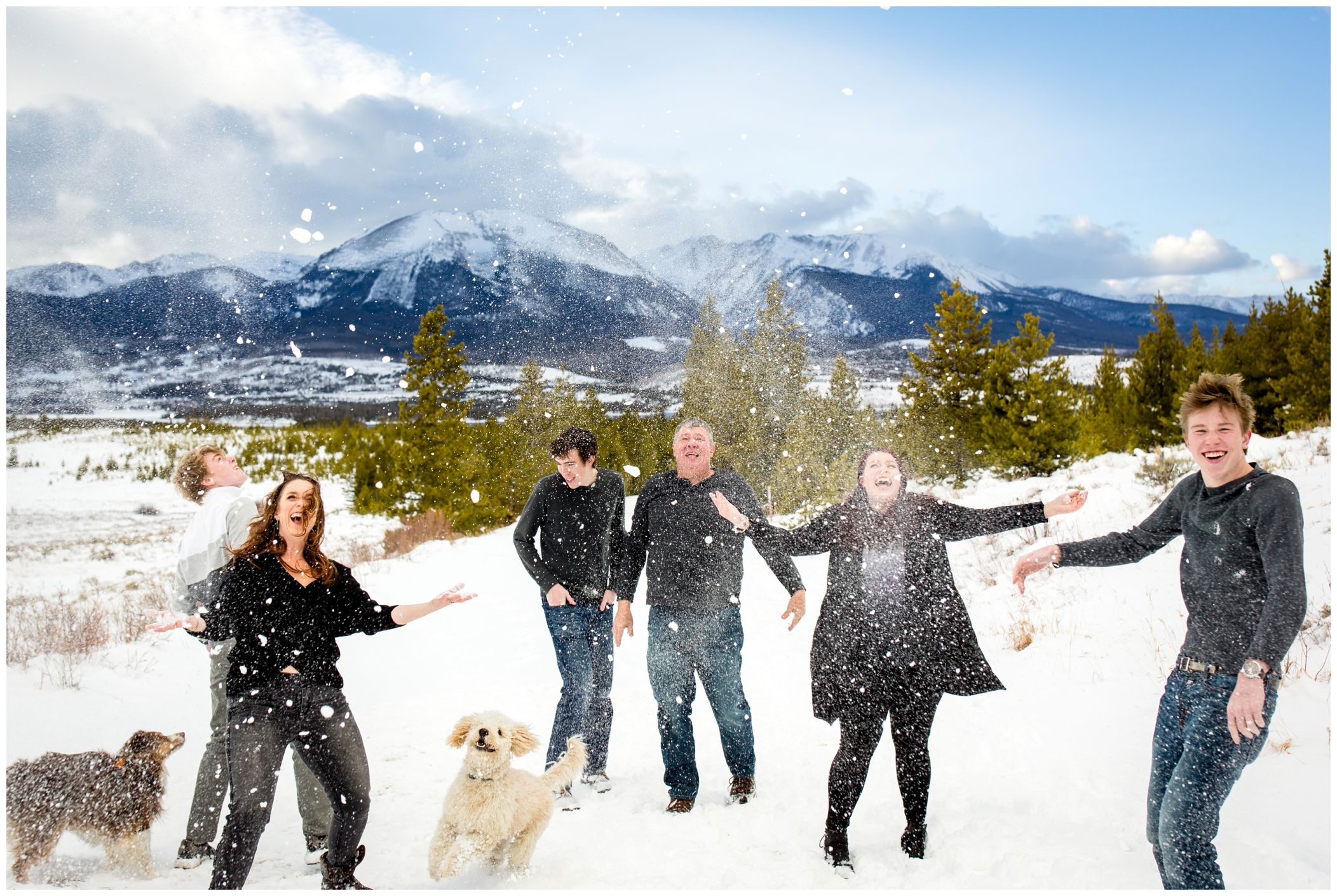 adult family throwing snow during Colorado winter family photos at Sapphire Point Breckenridge