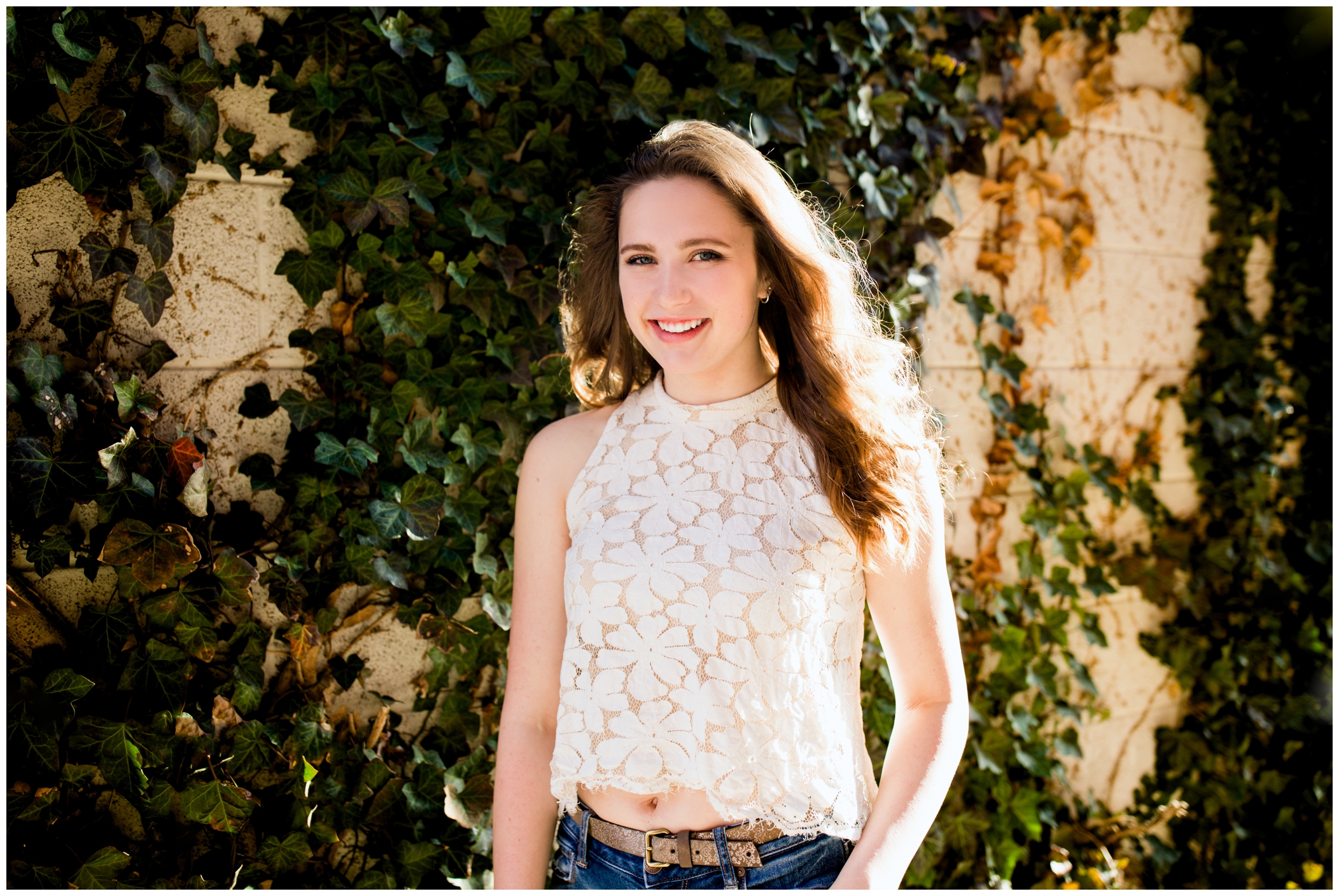 Silver Creek High student posing against an ivy wall at her Longmont senior portraits