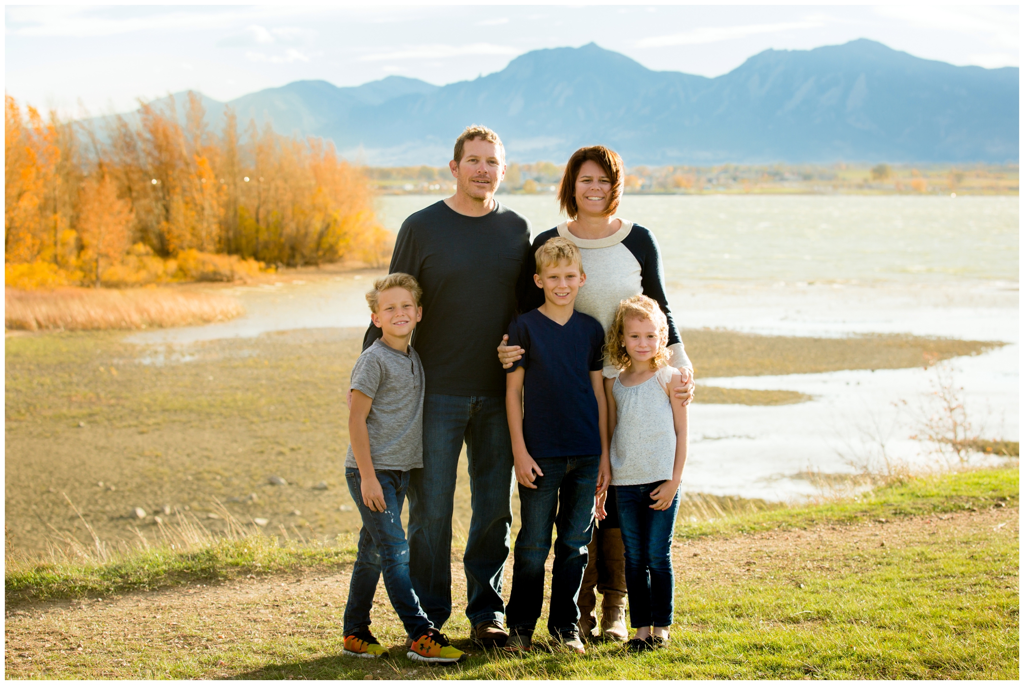 family posing with mountains in background by Longmont family photographer Plum Pretty Photo