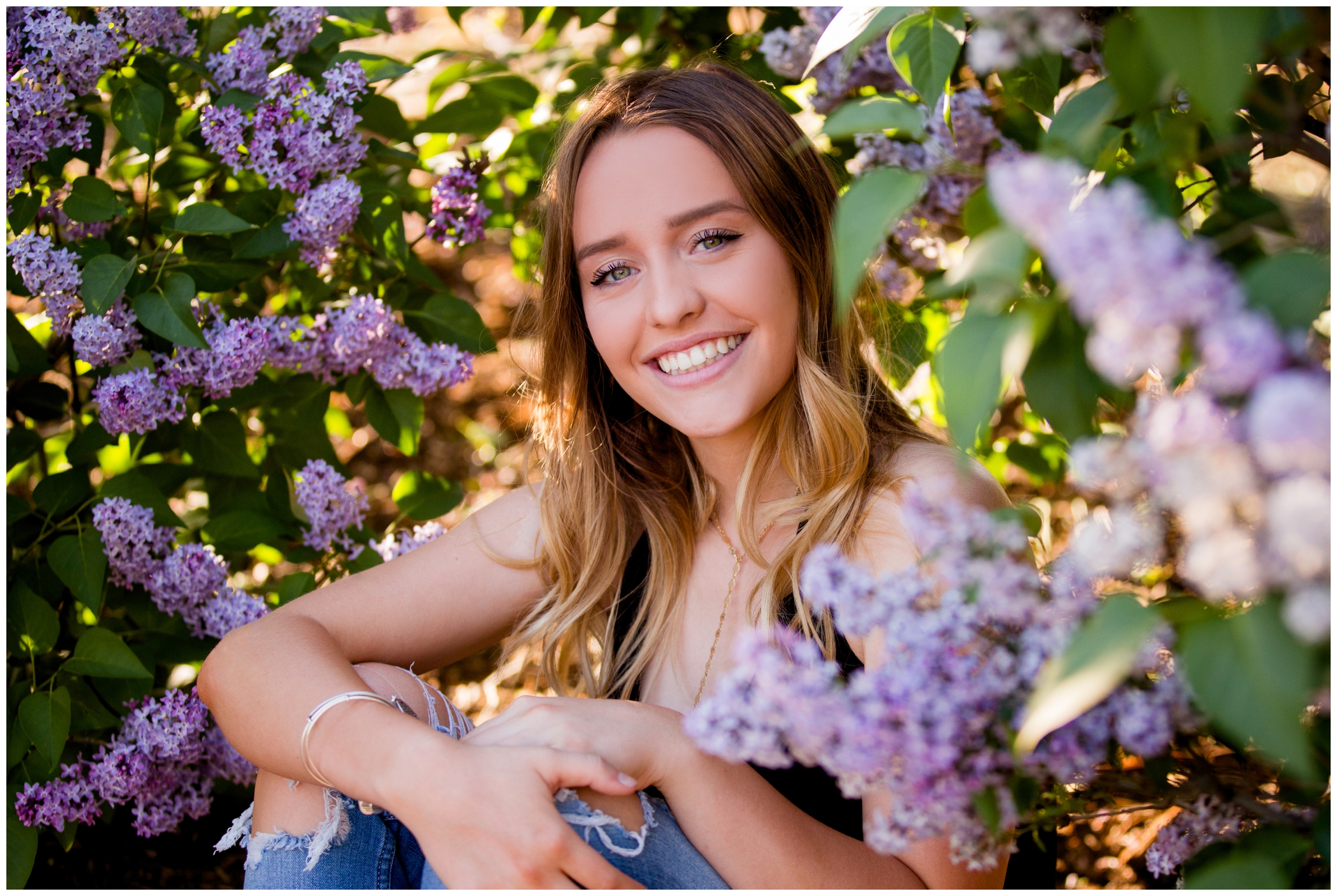 Longmont senior photos with lilac bush by Colorado portrait photographer Plum Pretty Photography