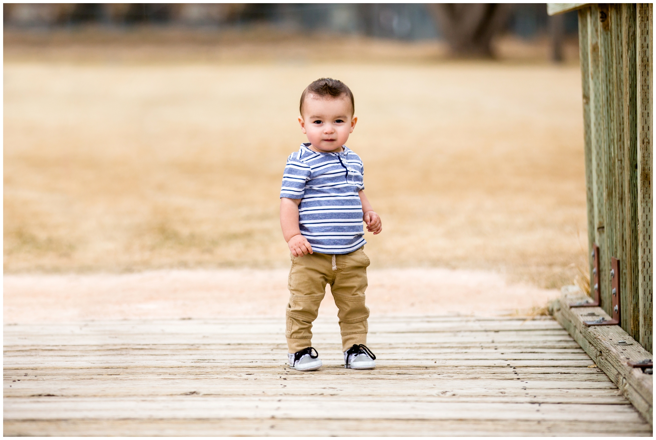 one year old boy standing on a bridge by Fort Collins child photographer Plum Pretty Photography 