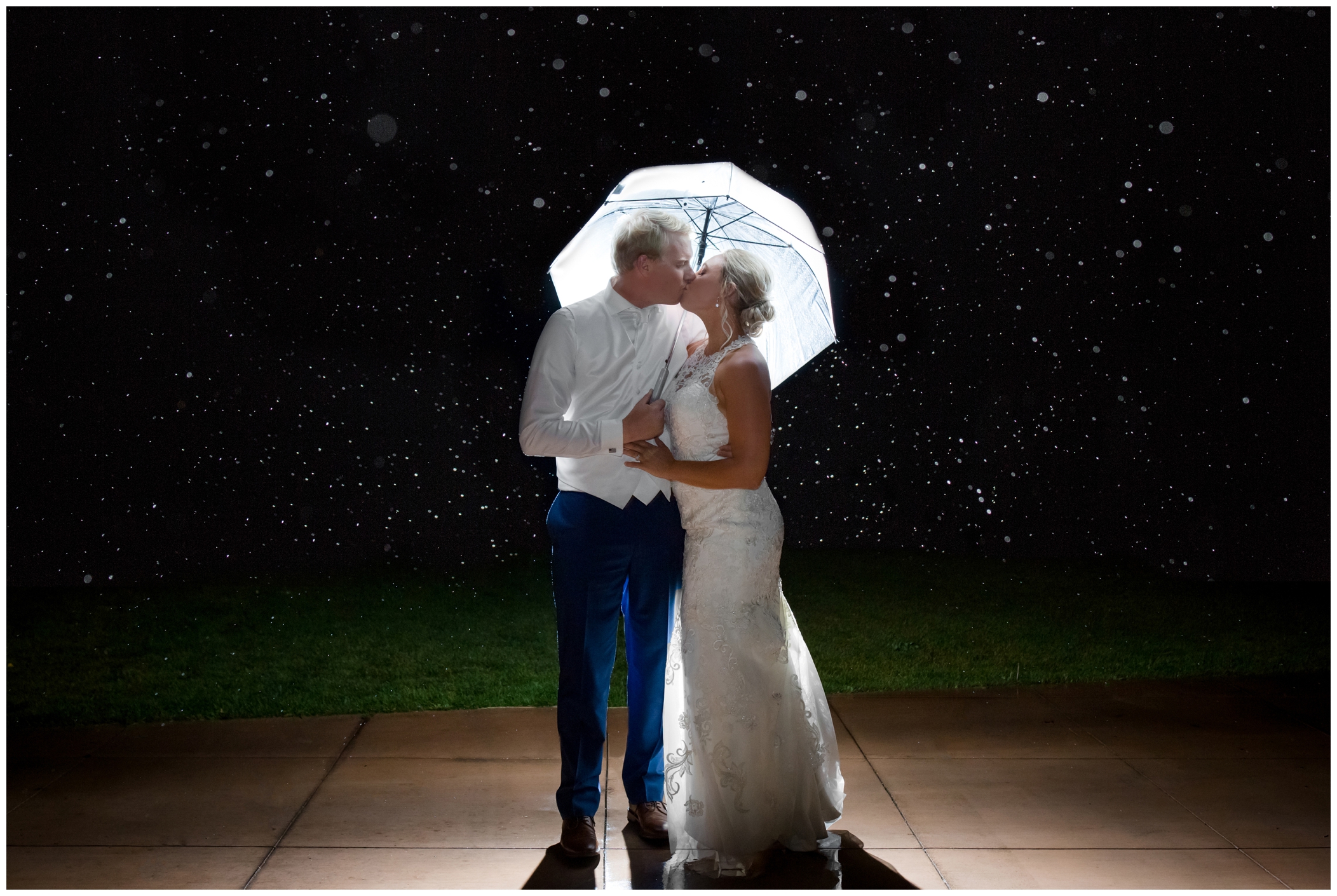 wedding couple standing in rain during Colorado nighttime wedding photos