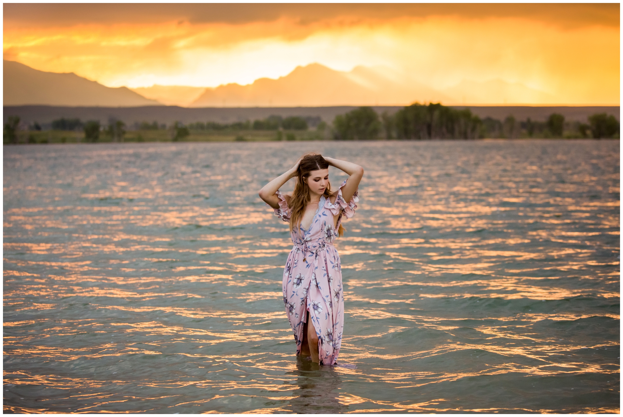 girl posing in Standley Lake at sunset during Westminster senior pictures