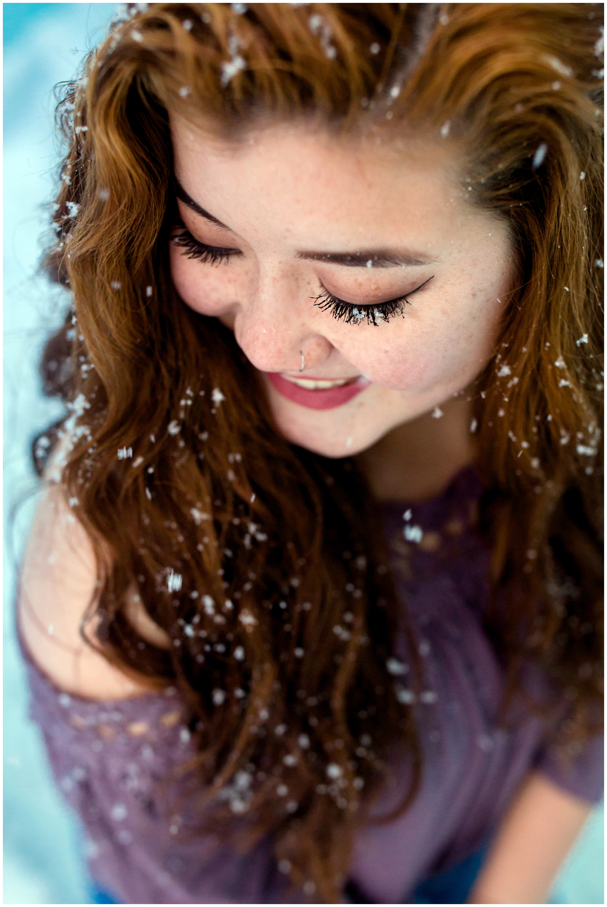 snowflakes on eyelashes during Colorado winter senior portraits 